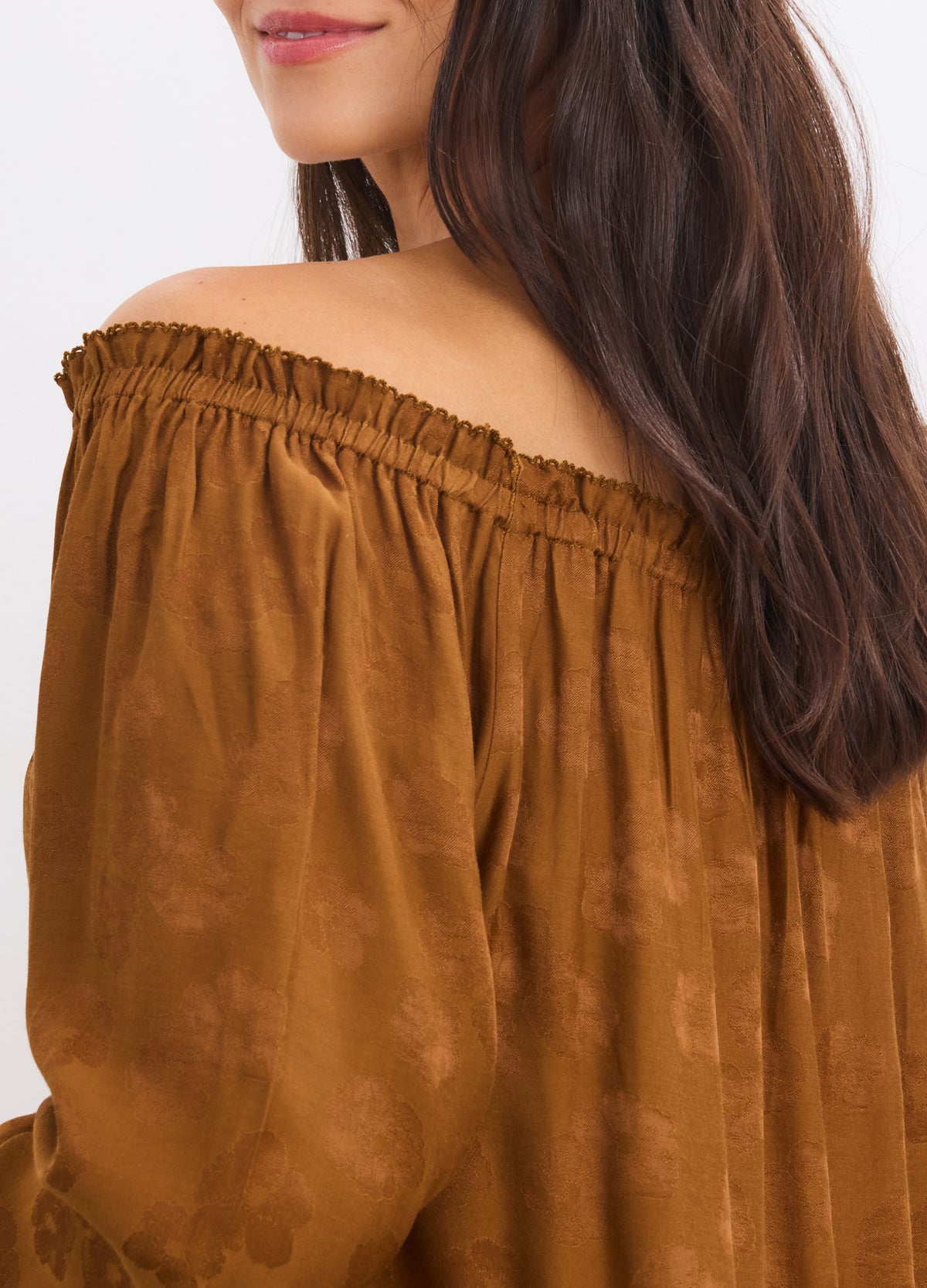 Brown off-the-shoulder jacquard mini dress with ruffled neckline and loose long sleeves.