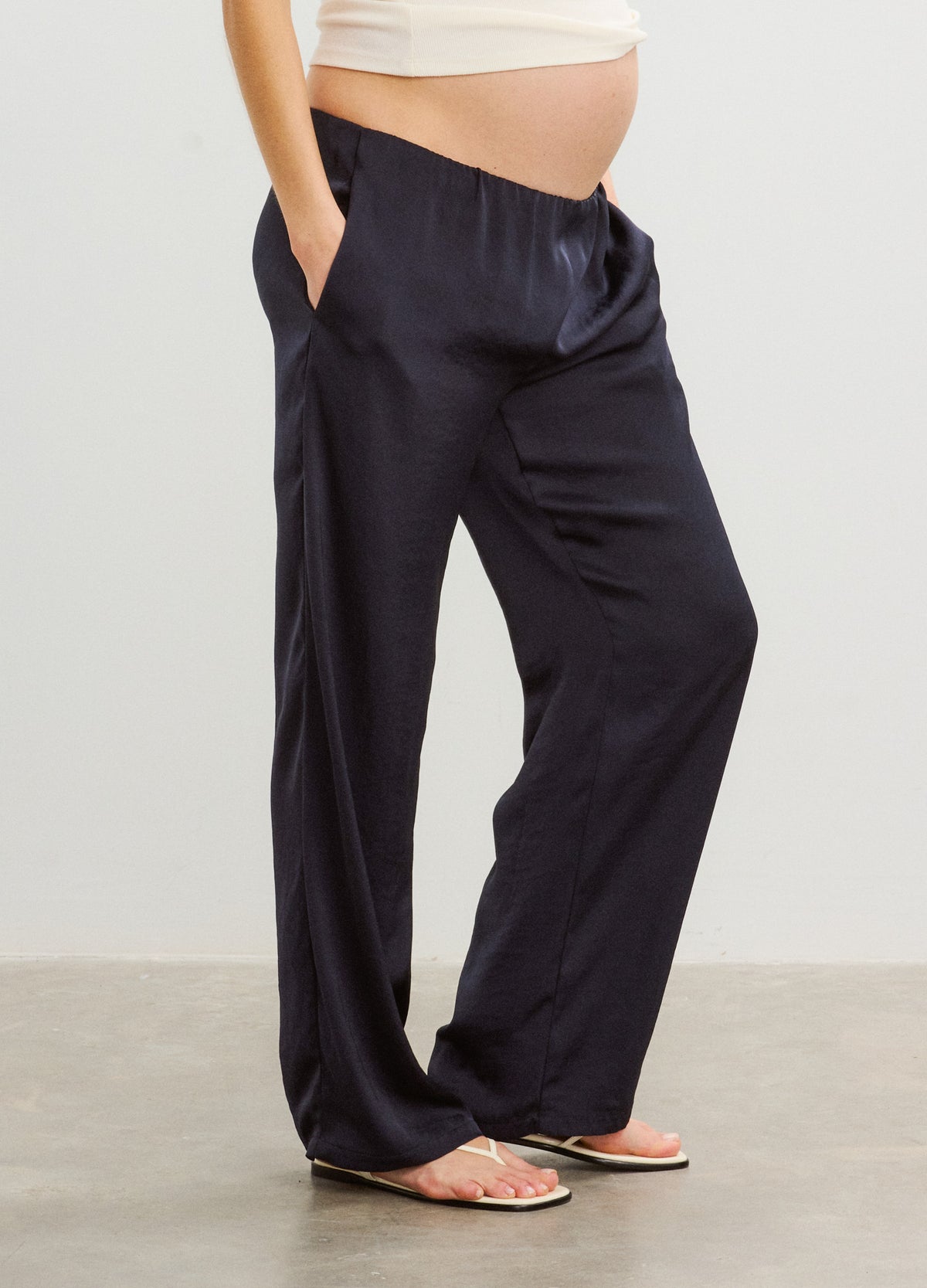 Black satin maternity pants with relaxed fit, elastic waistband, and side pockets.