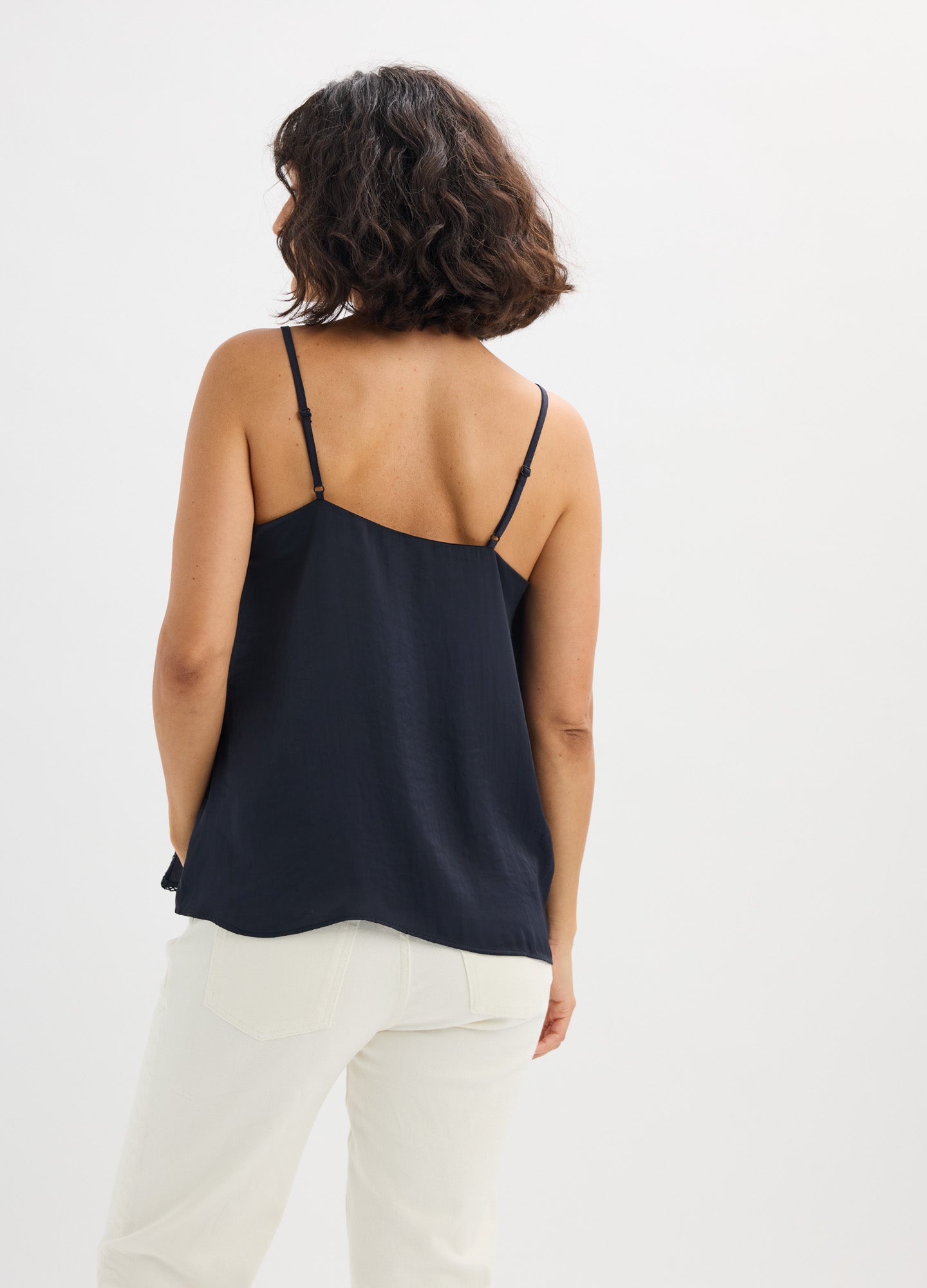 Black satin maternity camisole with thin adjustable straps and relaxed fit.