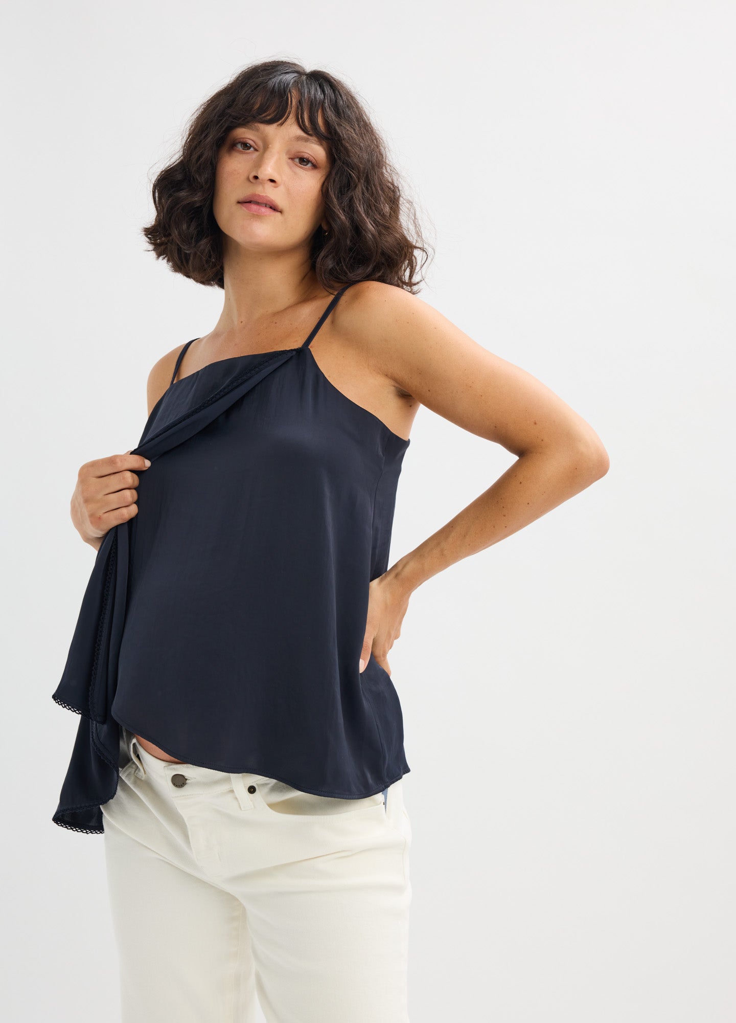 Navy blue satin maternity cami with delicate spaghetti straps and a loose, flowing fit.
