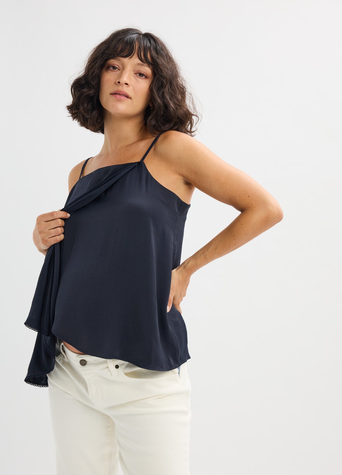 Navy blue satin maternity cami with delicate spaghetti straps and a loose, flowing fit.