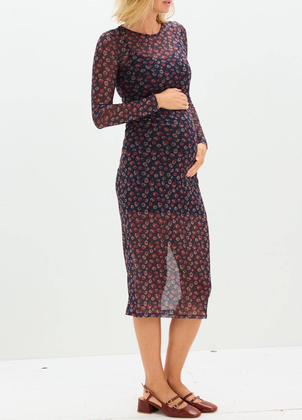 Navy blue midi maternity dress with red floral print, long sleeves, and fitted silhouette for pregnant women.
