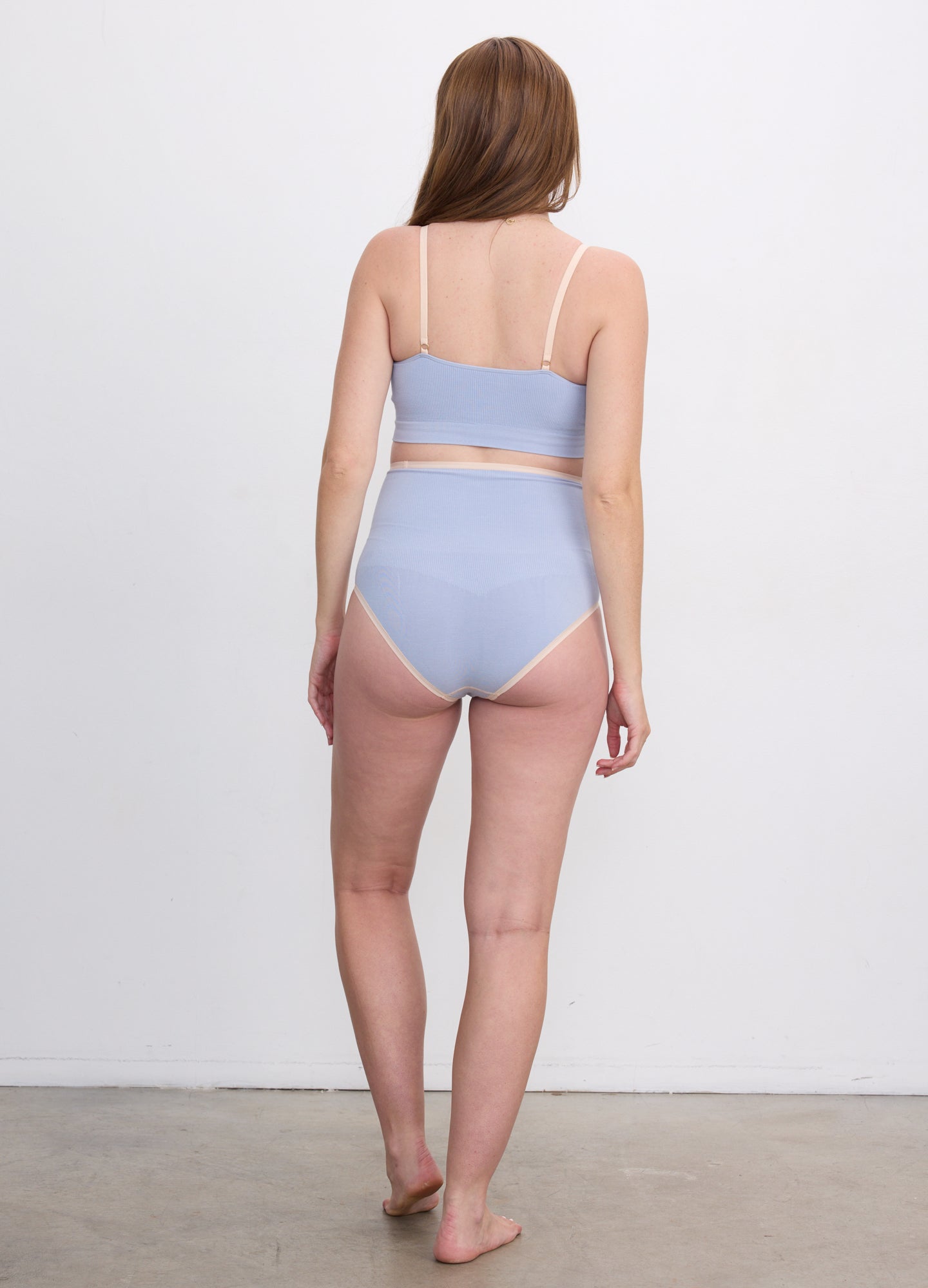 Light blue seamless high-waisted maternity briefs with smooth, stretchy fabric and full coverage back.