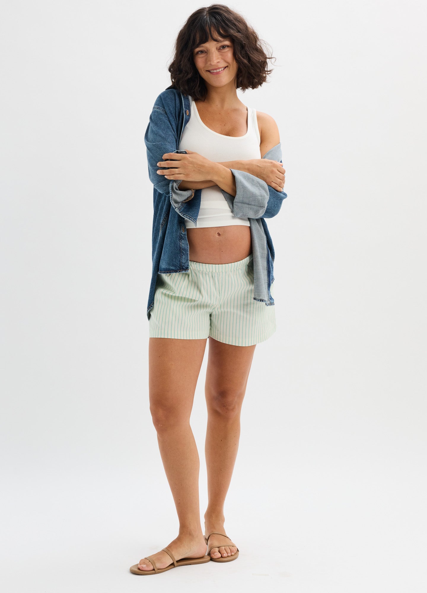 Light green maternity shorts with adjustable side ties, soft fabric, comfortable fit for pregnancy.