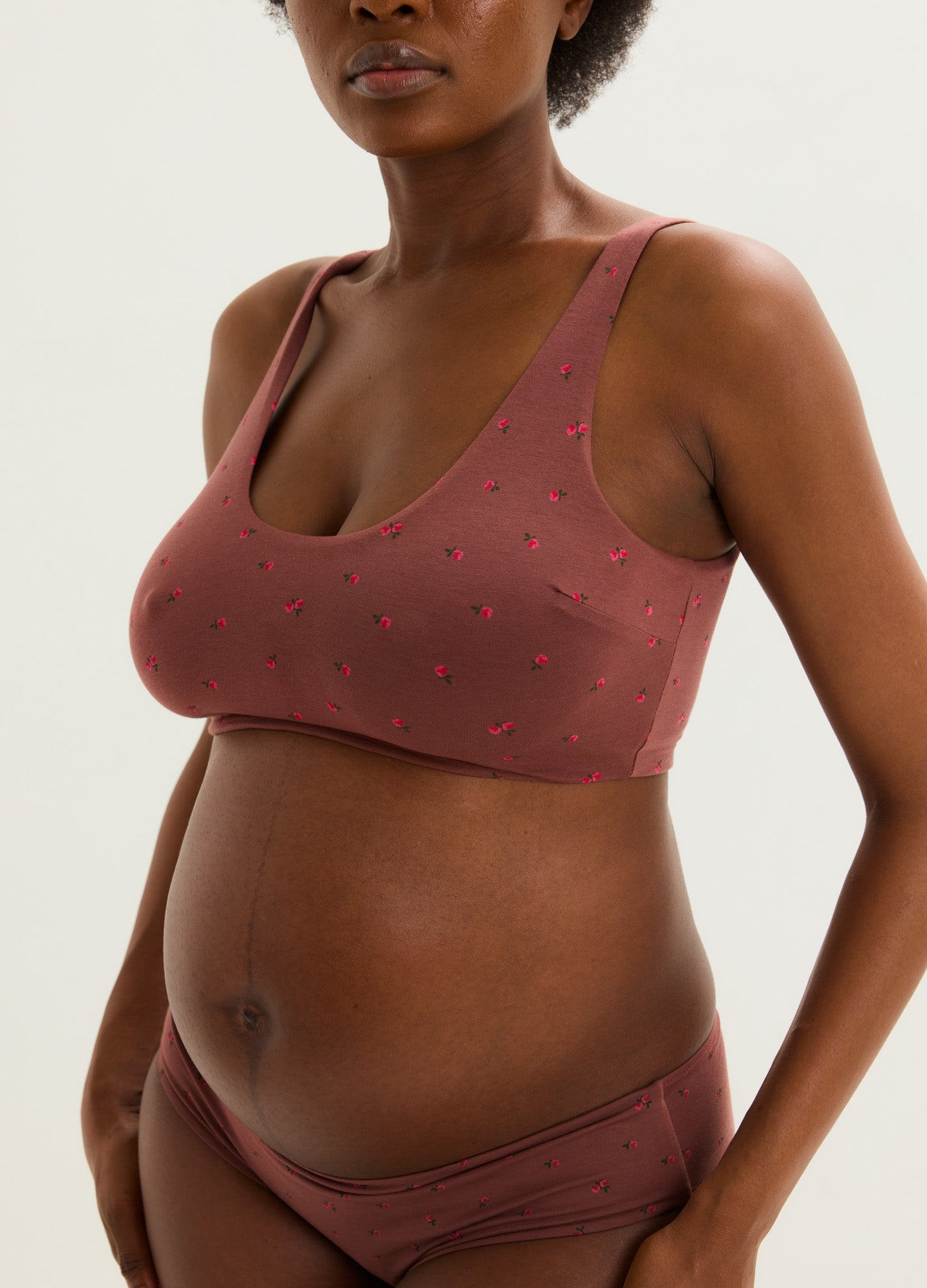 Mauve maternity bra with small pink floral print, soft fabric, wide straps, designed for pregnant women.