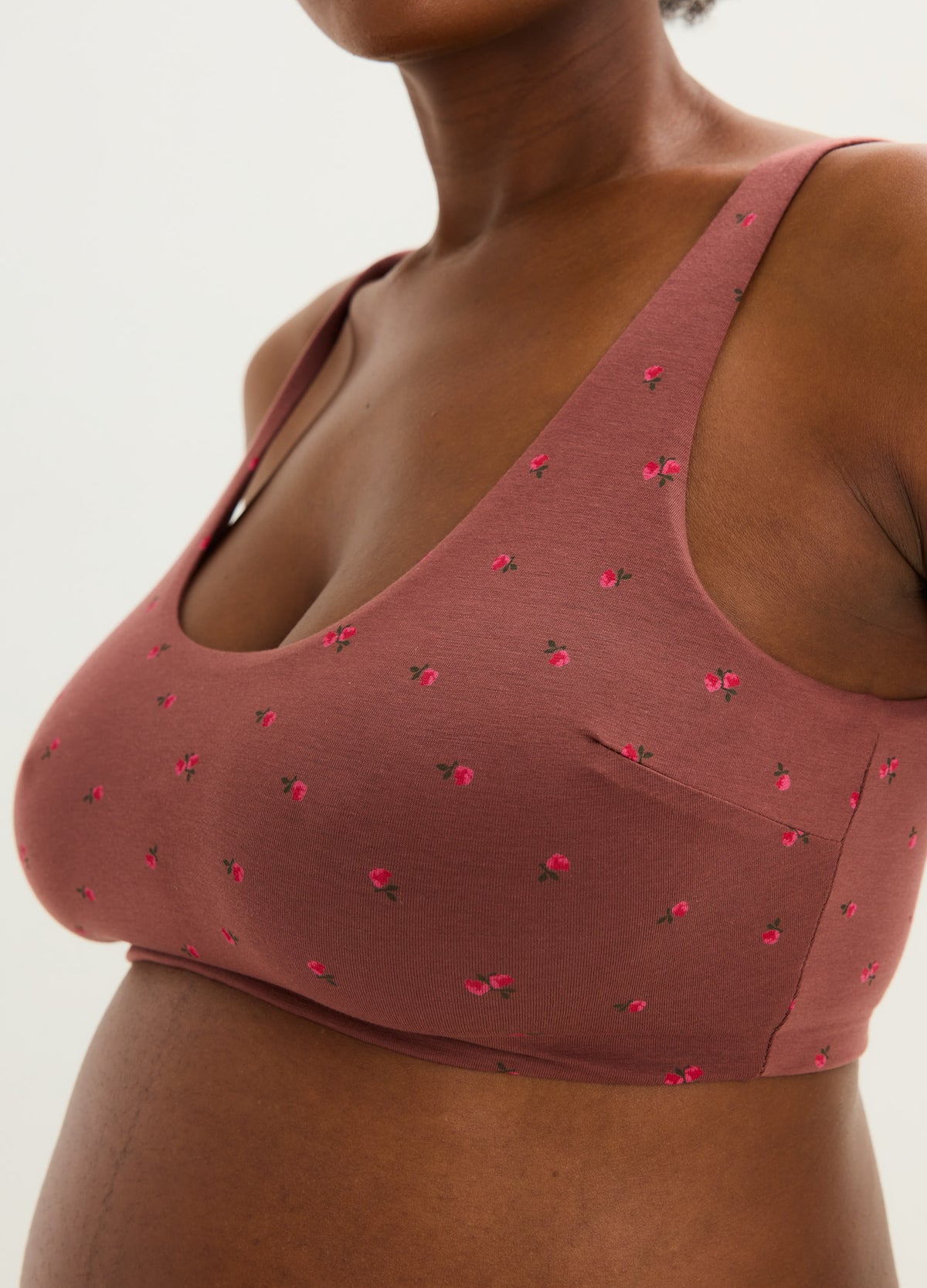 Mauve wireless maternity bra with small red floral print and wide supportive straps.