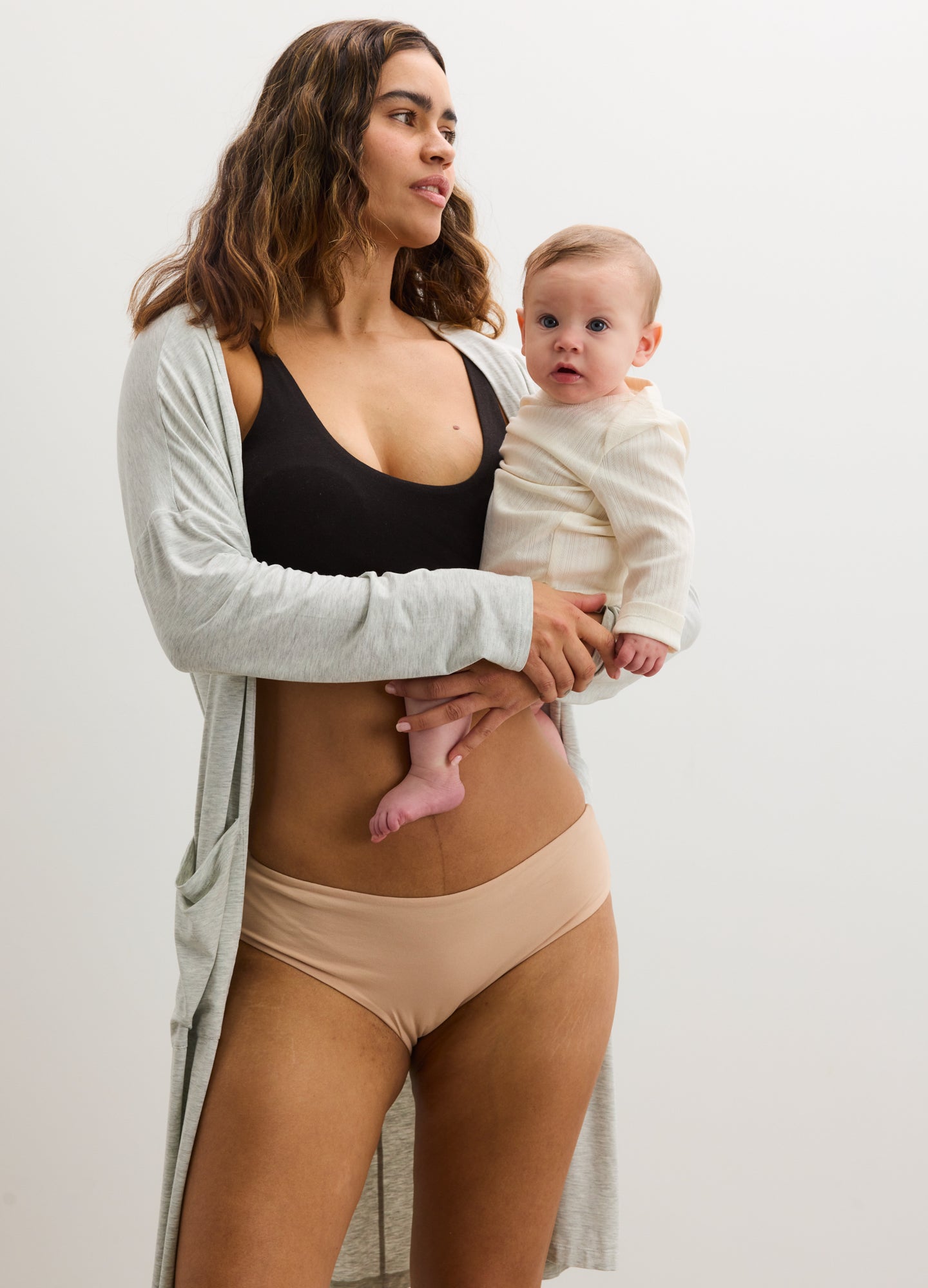 Black maternity bra with wide straps and scoop neckline, shown with beige seamless maternity briefs.