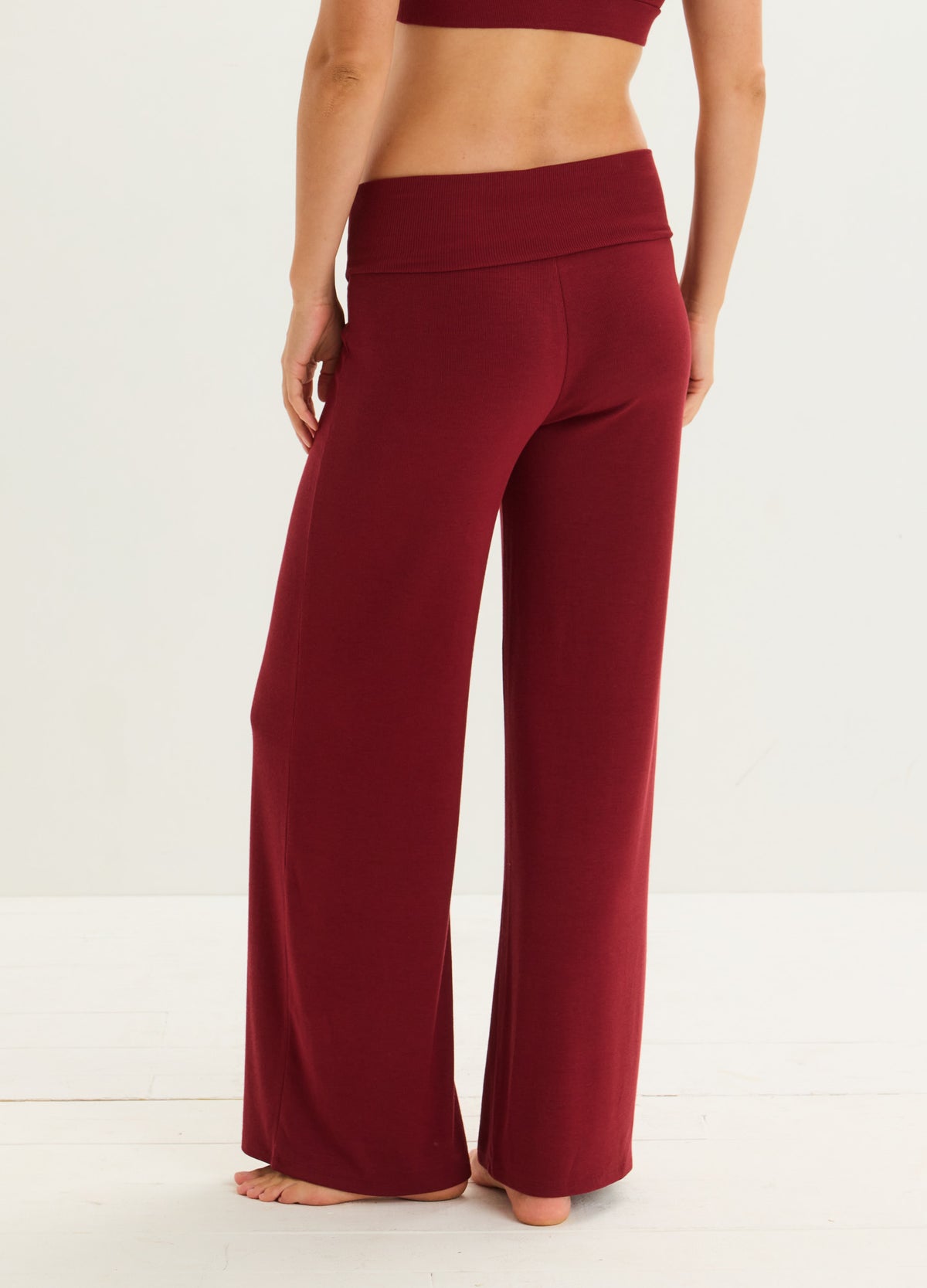 Burgundy ribbed maternity lounge pants with a wide waistband and relaxed straight legs.