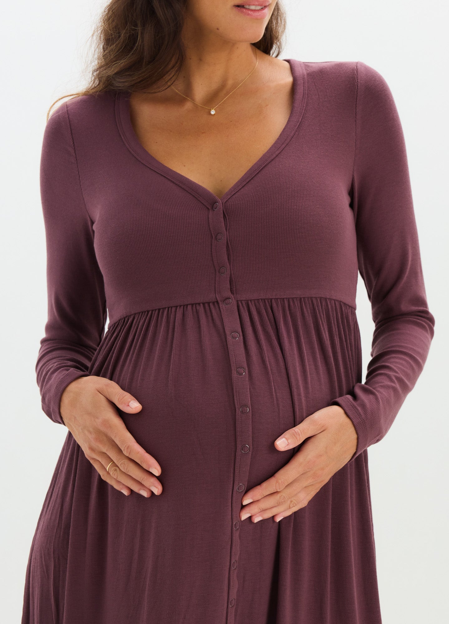 Long-sleeve ribbed maternity dress in deep plum with V-neck and empire waist for nursing access.