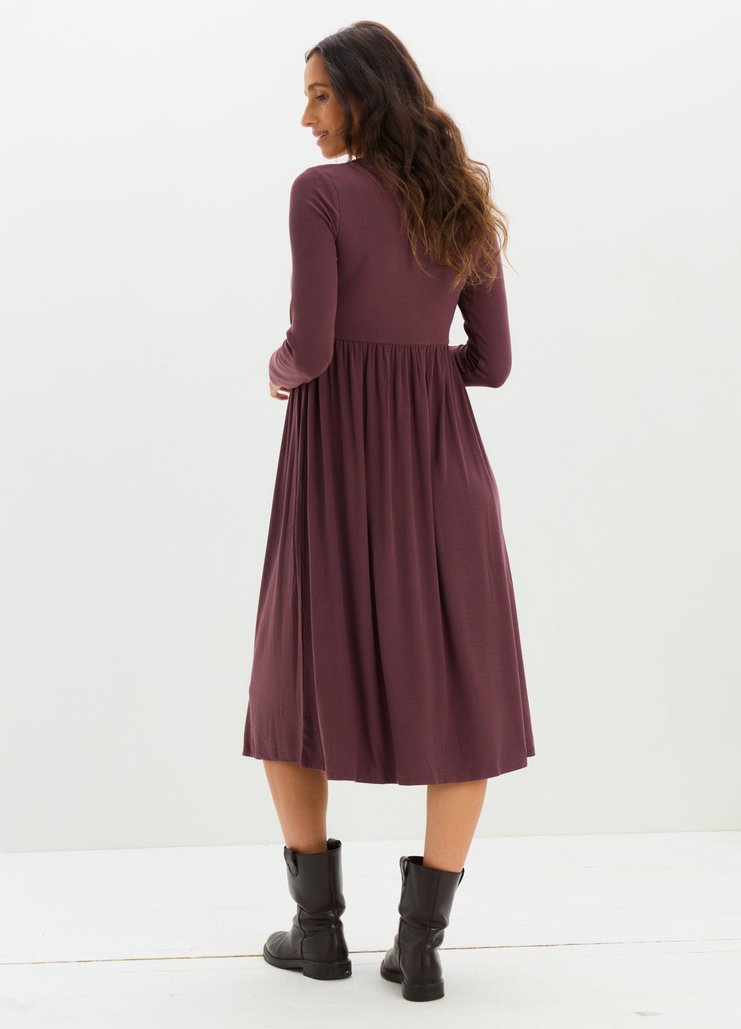 Mauve rib-knit midi nursing dress with long sleeves and gathered waist, worn with black ankle boots.