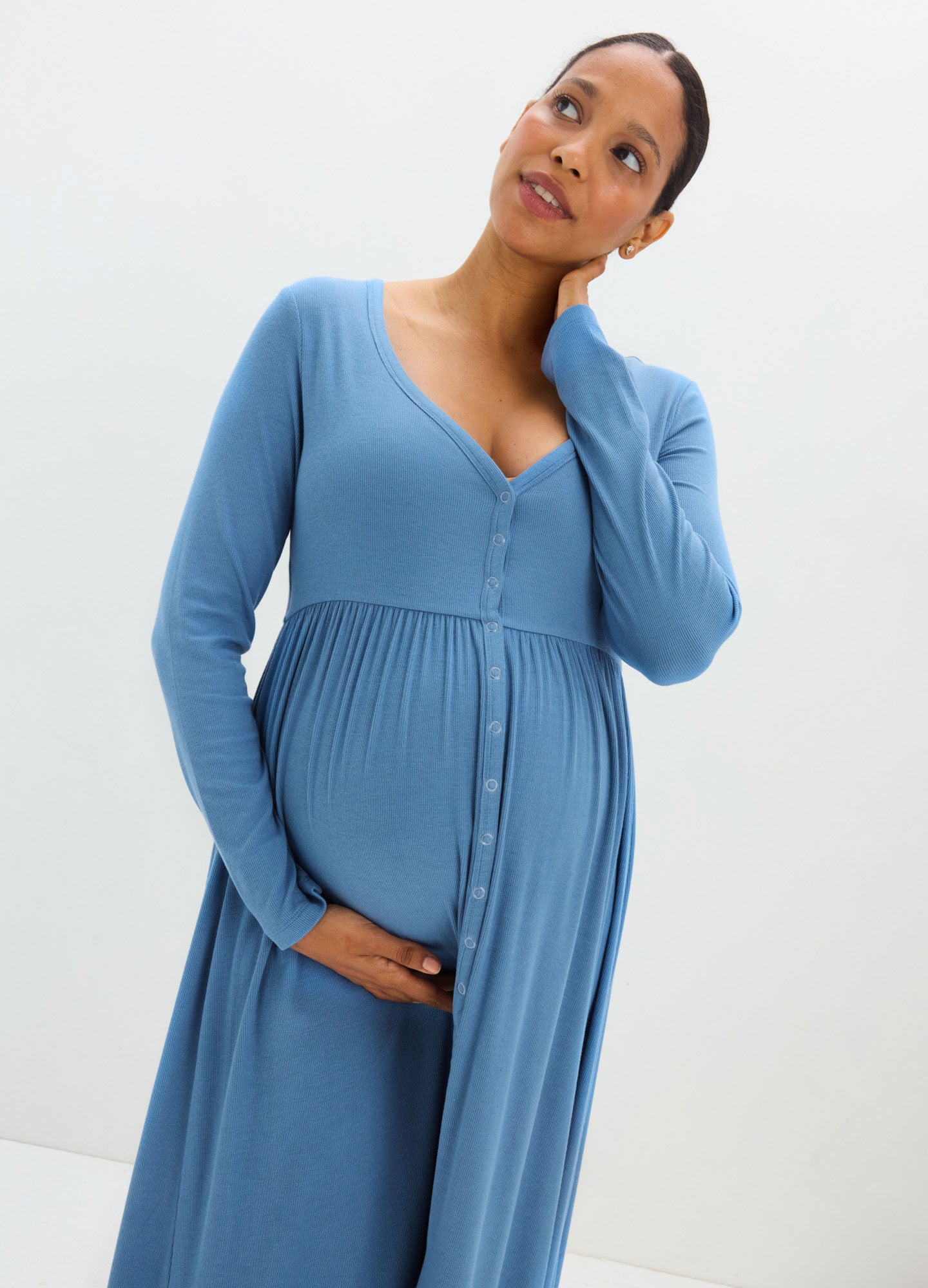 Soft blue ribbed maternity nursing dress with long sleeves and a buttoned front panel.