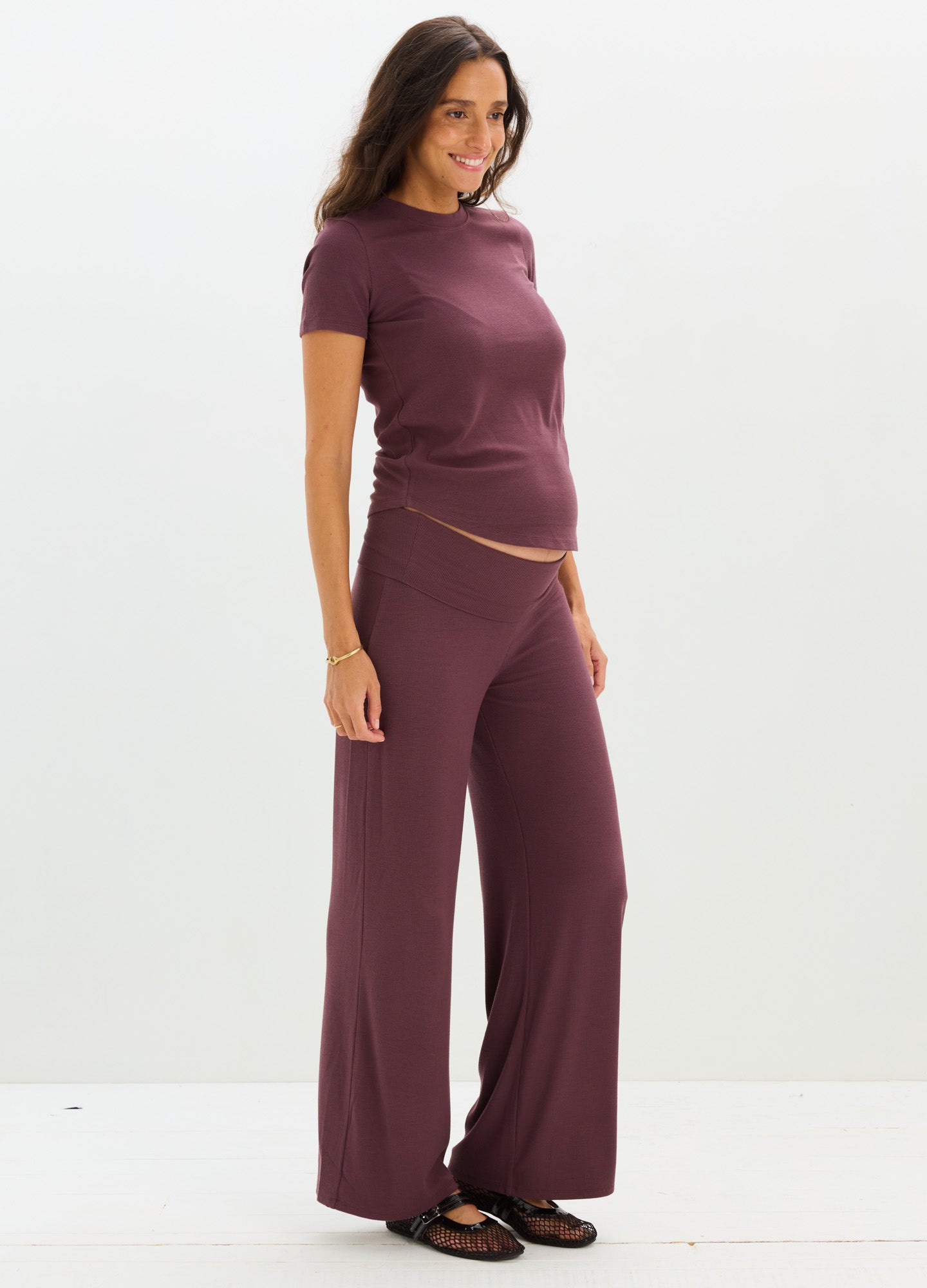 Maternity soft ribbed set with relaxed wide-leg pants and short-sleeve top in deep plum color.