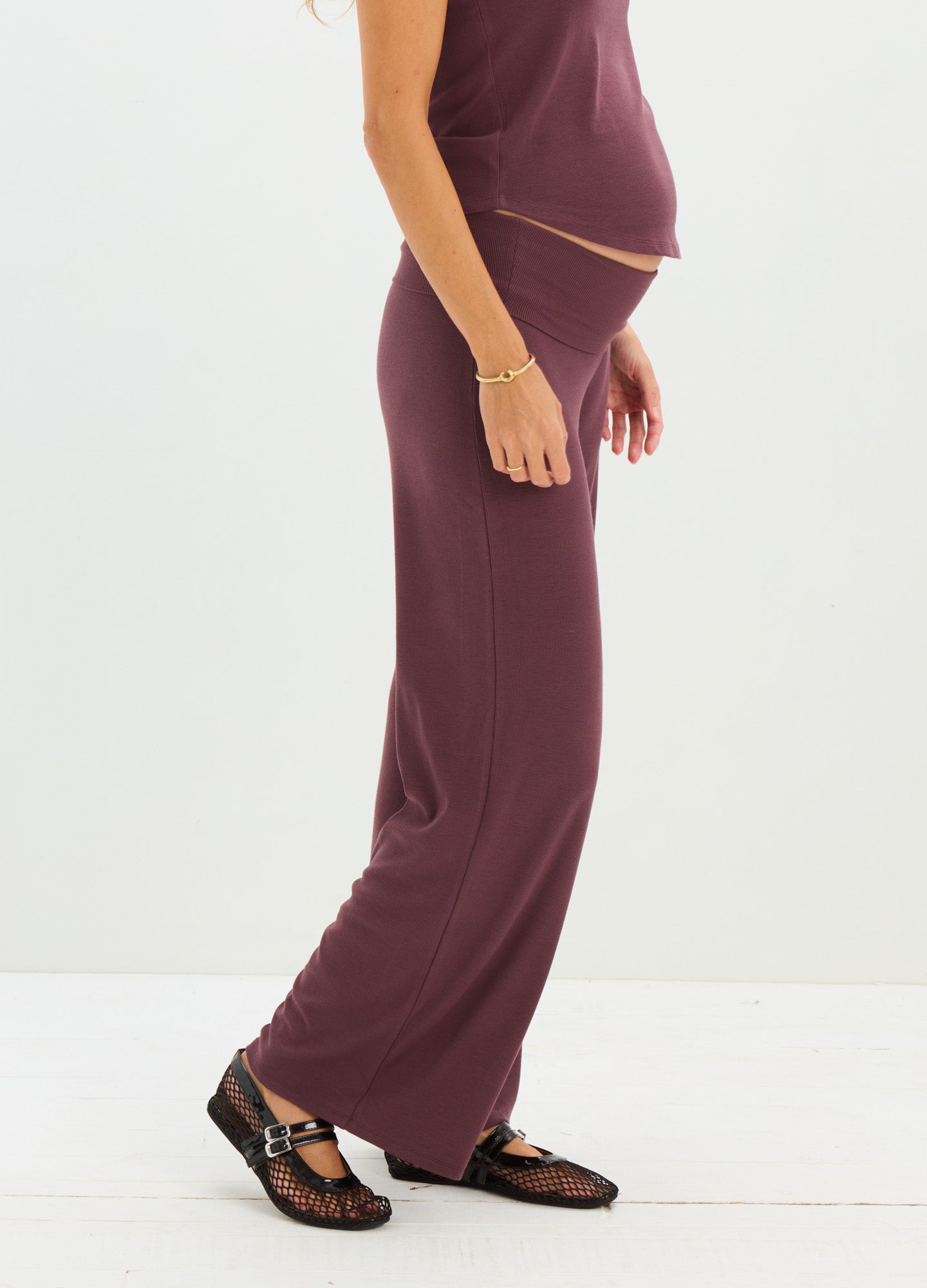 Maternity ribbed knit relaxed pants in deep plum with elastic waistband and wide legs.