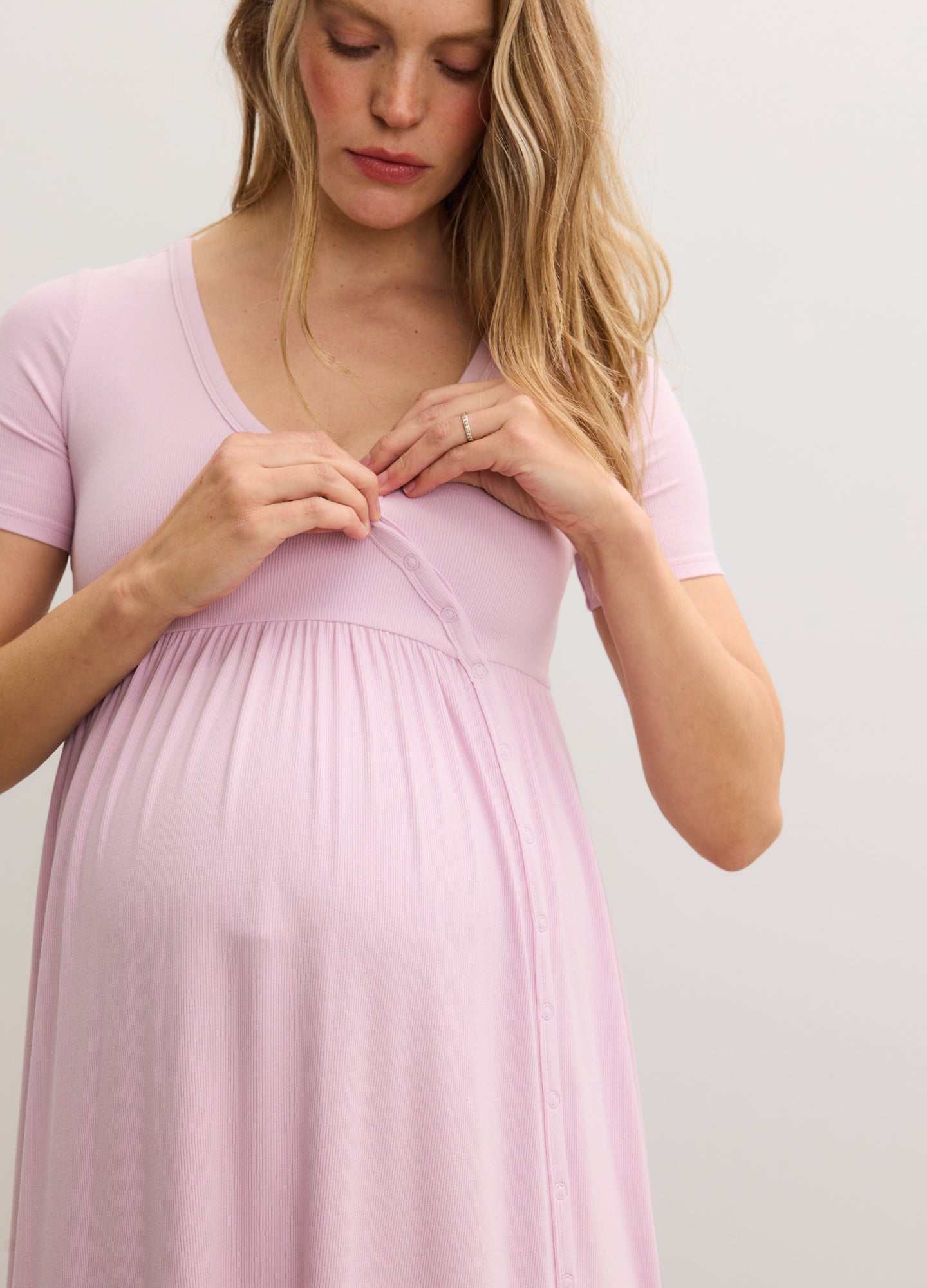 Light pink ribbed nursing maxi dress with short sleeves and side seams, worn by pregnant model.