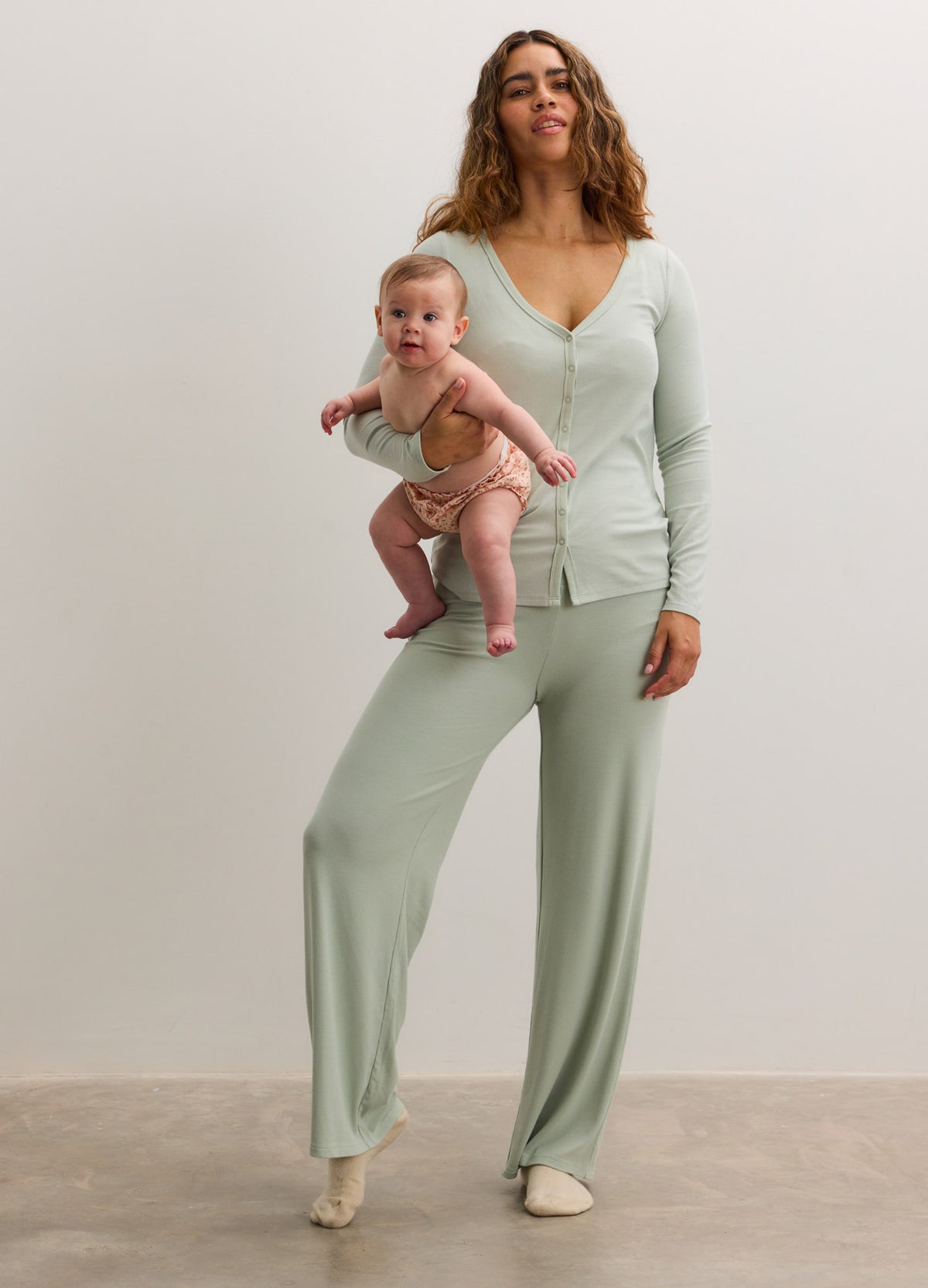Light green ribbed nursing cardigan with matching wide-leg pants, soft stretchy fabric, button front.