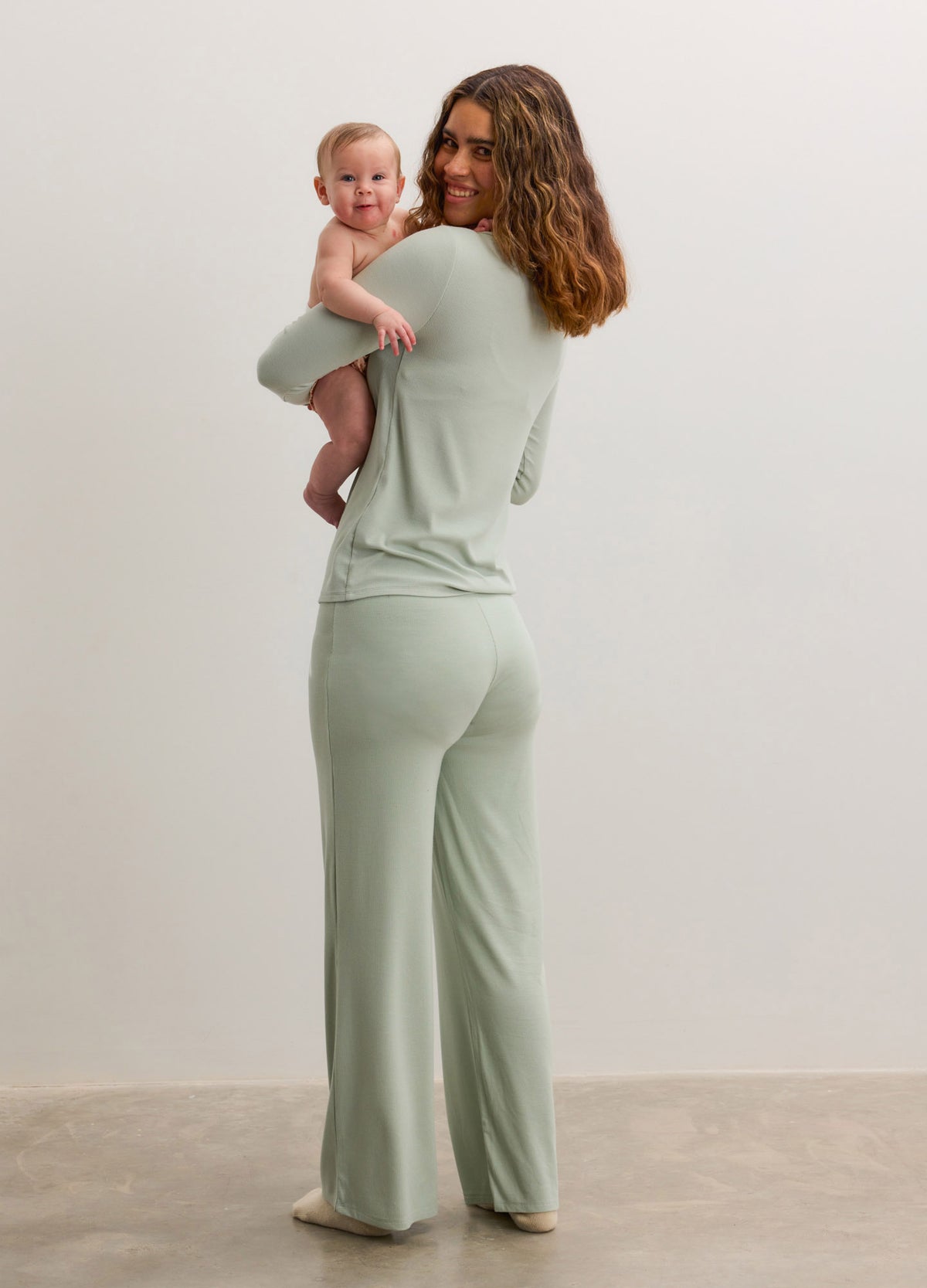 Light sage green ribbed nursing cardigan with matching wide-leg pants, soft knit fabric, maternity-friendly fit.