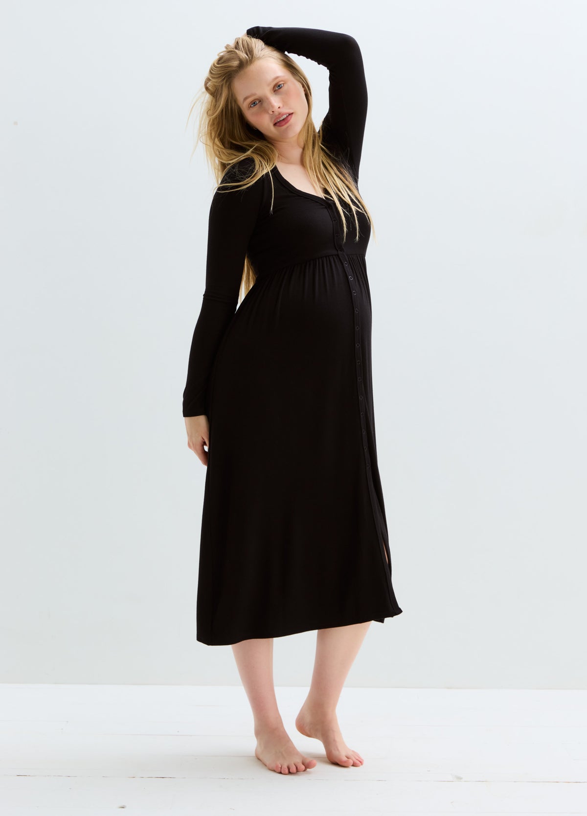 Black ribbed long-sleeve maternity nursing dress with a fitted empire waist and midi length.