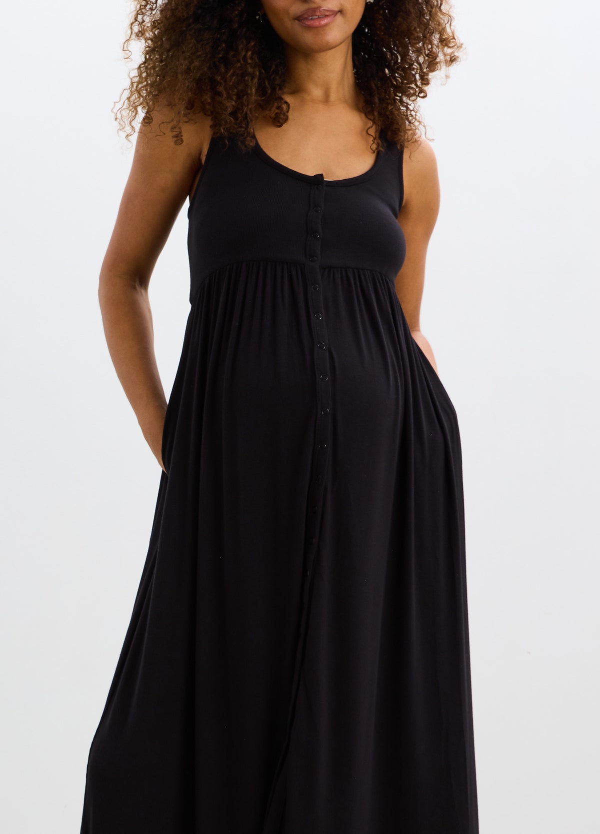 Black ribbed nursing tank dress with scoop neck and empire waist, designed for maternity and comfort.
