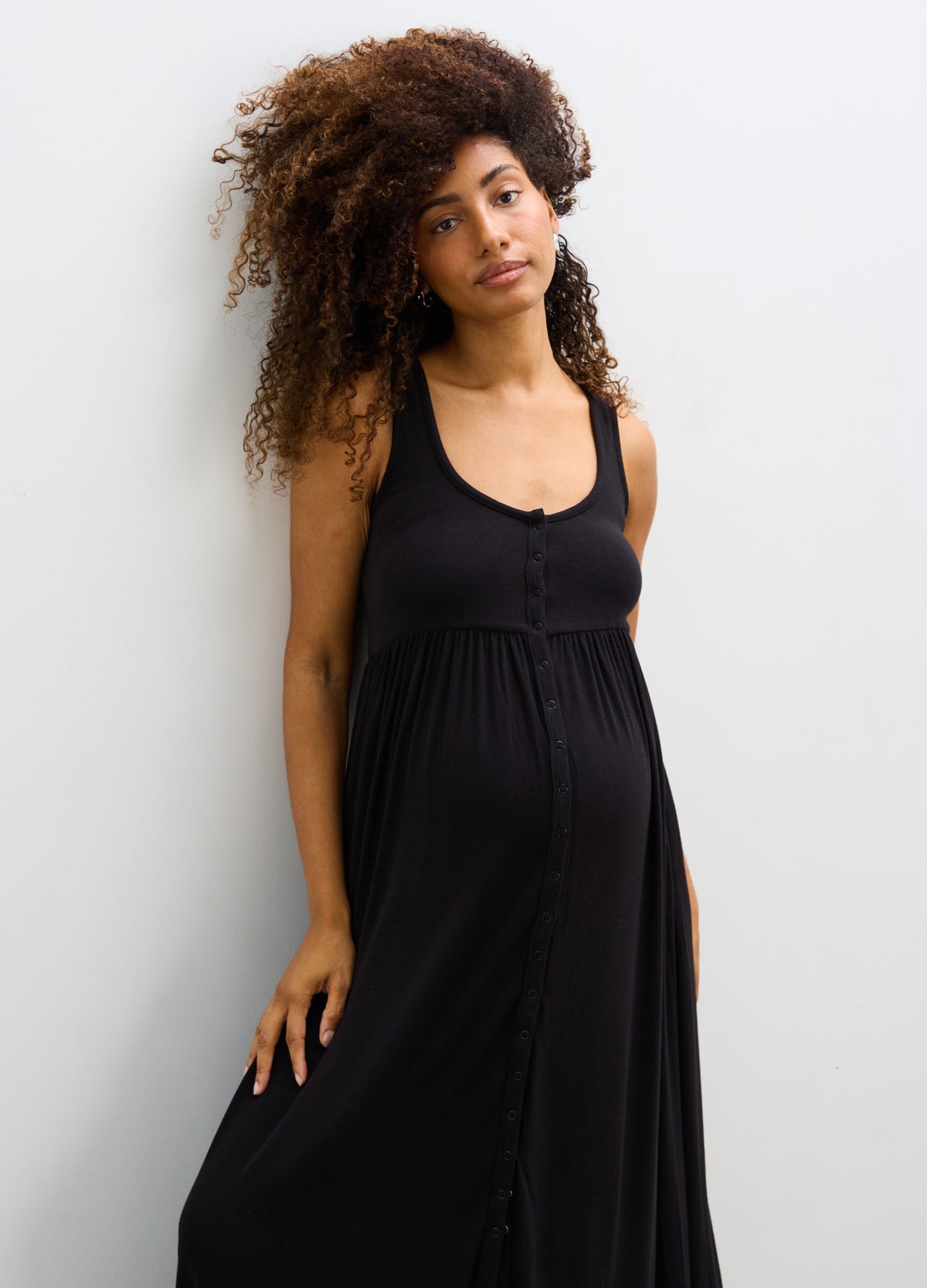Black ribbed nursing tank dress with scoop neckline and empire waist, designed for maternity comfort.