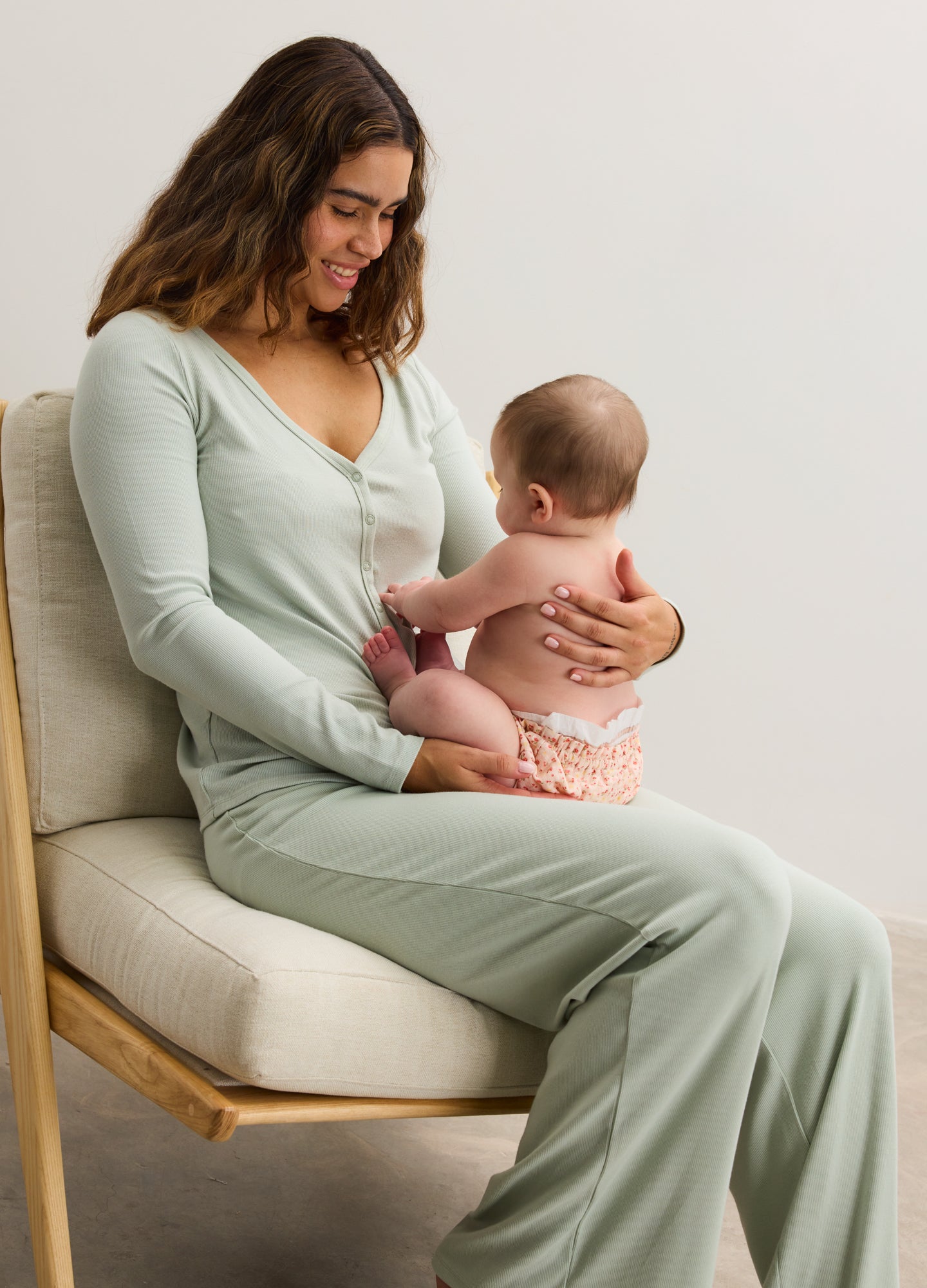 Light sage green ribbed maternity lounge pants with relaxed fit and high waistband.