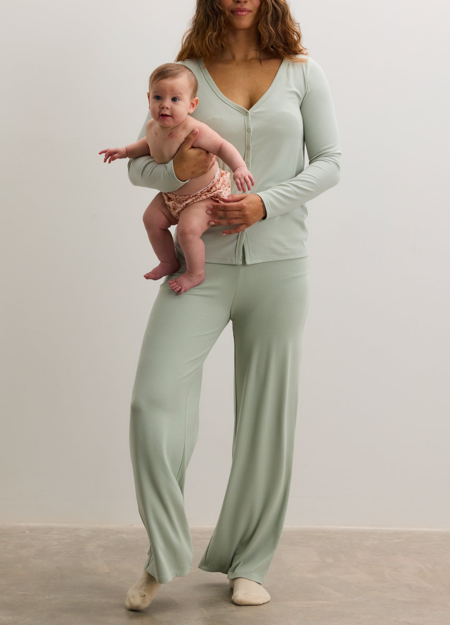 Light green soft rib knit maternity pants with a relaxed, wide-leg fit and elastic waist.