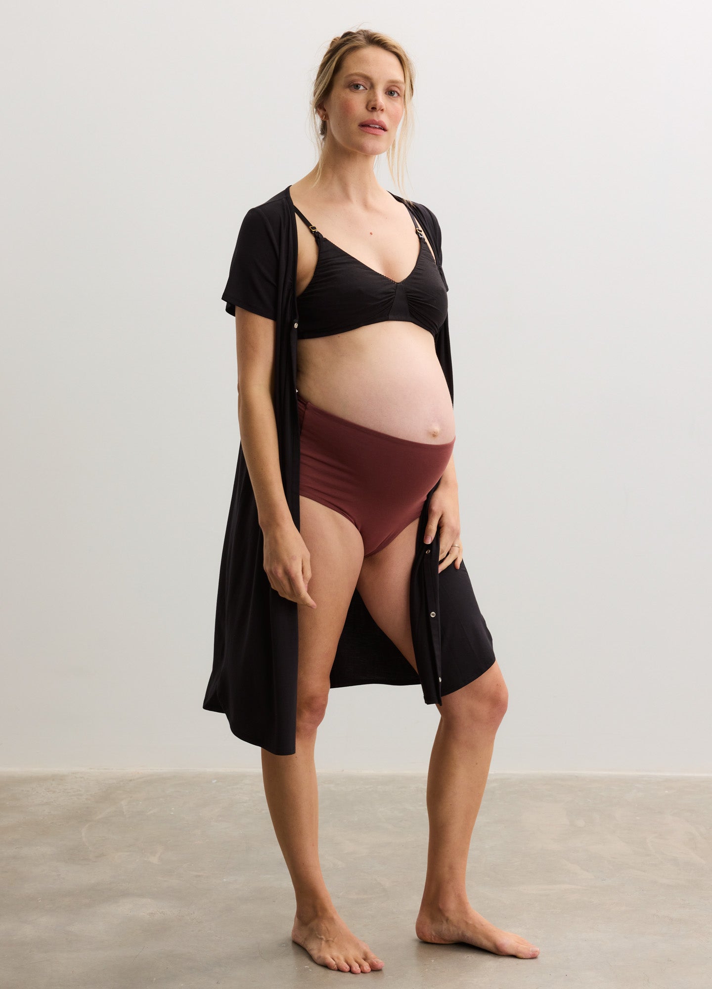 Black soft-knit maternity robe over matching bra and high-waist burgundy delivery nightgown panties.