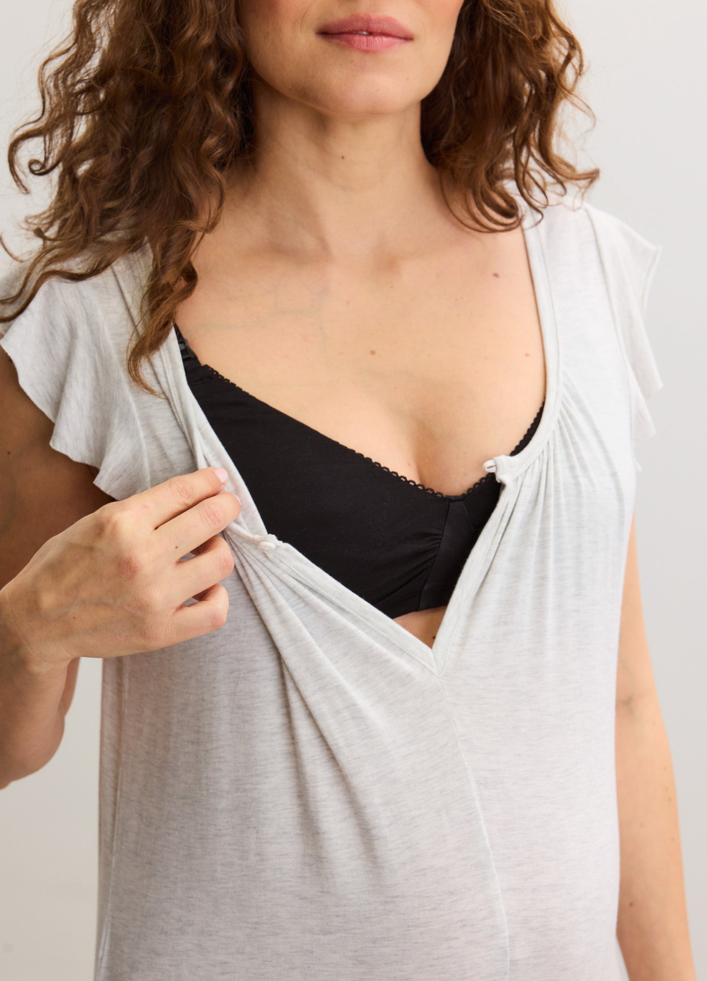 Light gray soft jersey maternity jumpsuit with short sleeves and discreet nursing access.