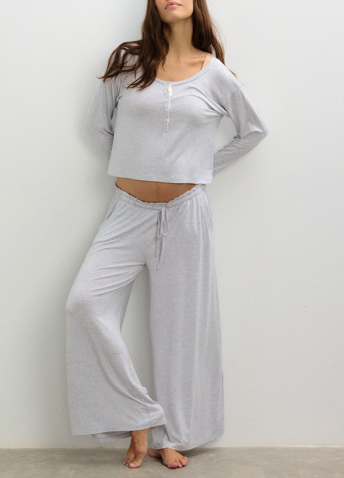 Light gray soft knit maternity lounge pants with a relaxed wide-leg fit and drawstring waist.