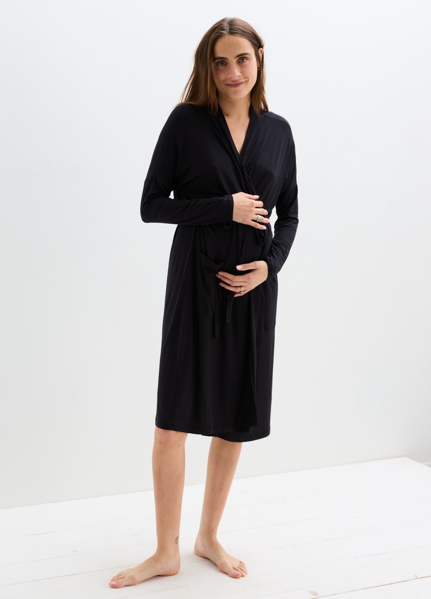 Black knee-length maternity robe with long sleeves, soft fabric, and a wrap tie belt.