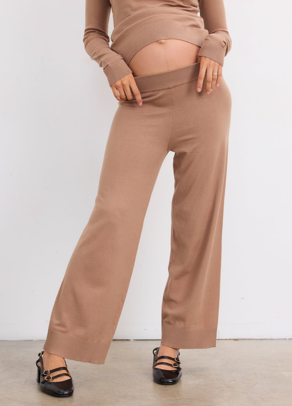 Mocha knit maternity crop pants with elastic waist on pregnant model, soft and comfortable fit.