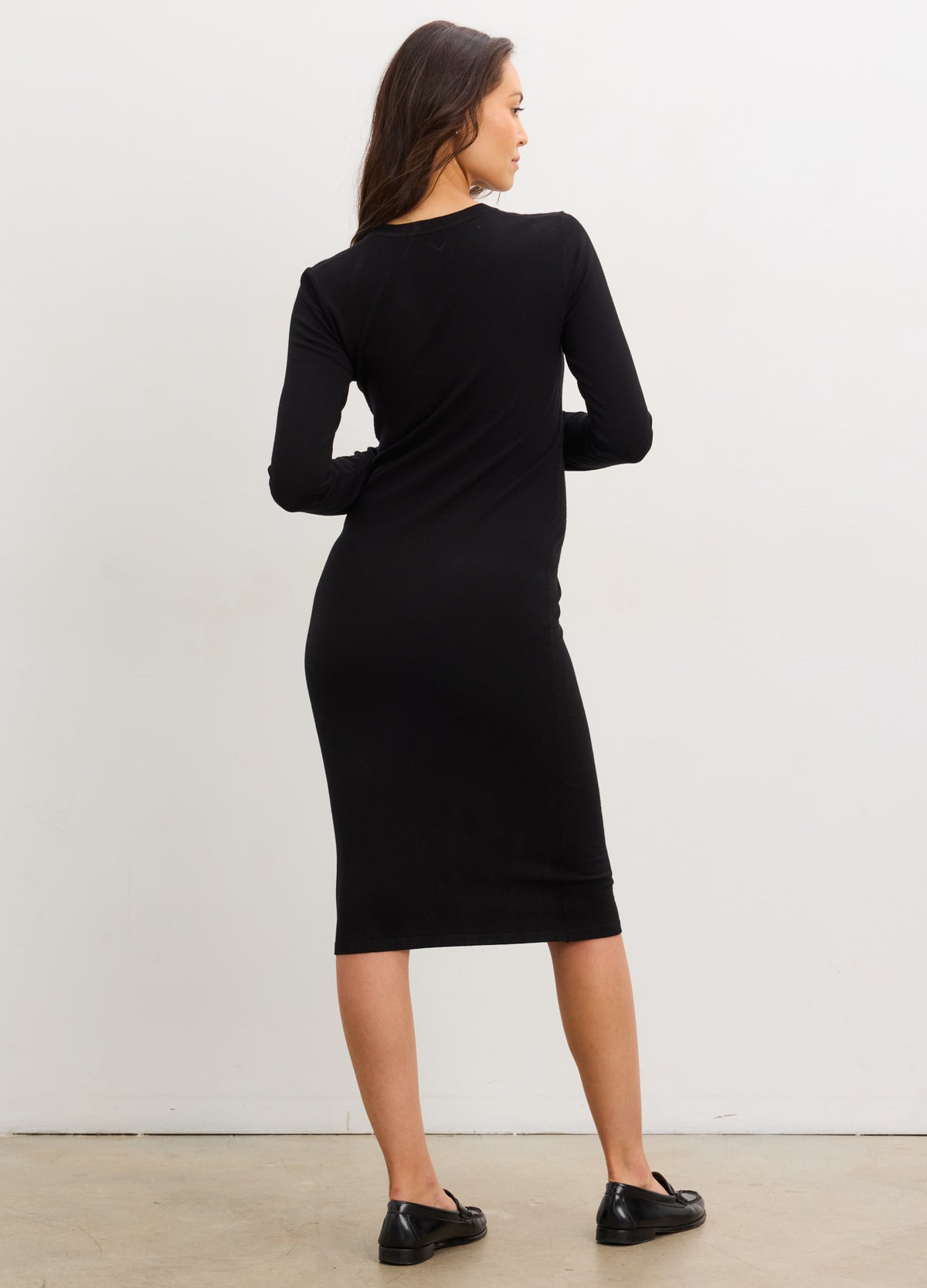 Black knit midi dress with long sleeves and bodycon fit, designed for maternity comfort.