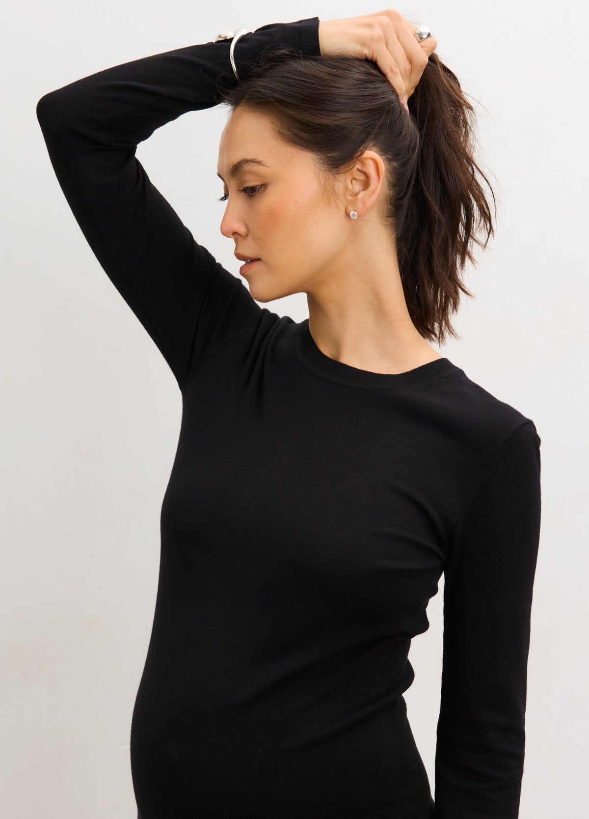 Black knit long-sleeve maternity dress with a fitted silhouette and soft stretch fabric.