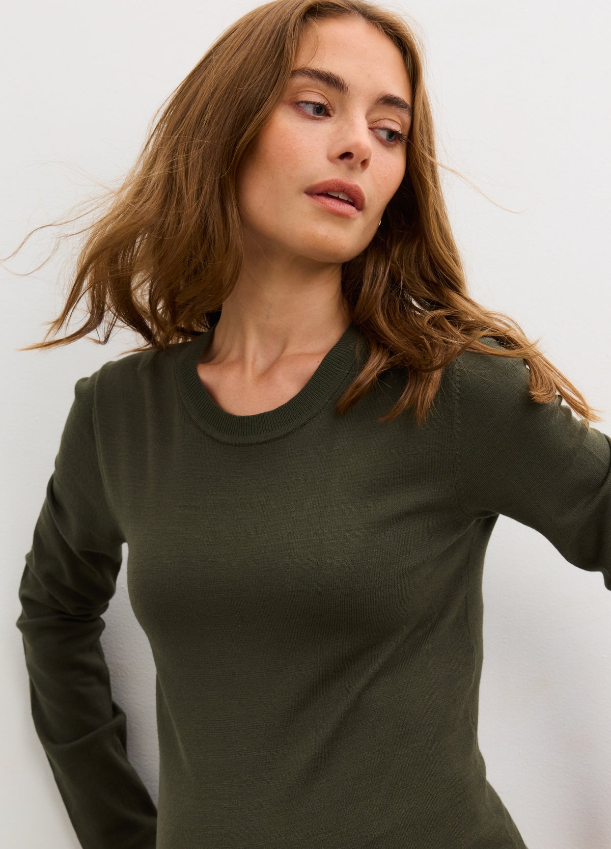 Spruce green knit maternity dress with long sleeves and fitted silhouette for pregnant women.