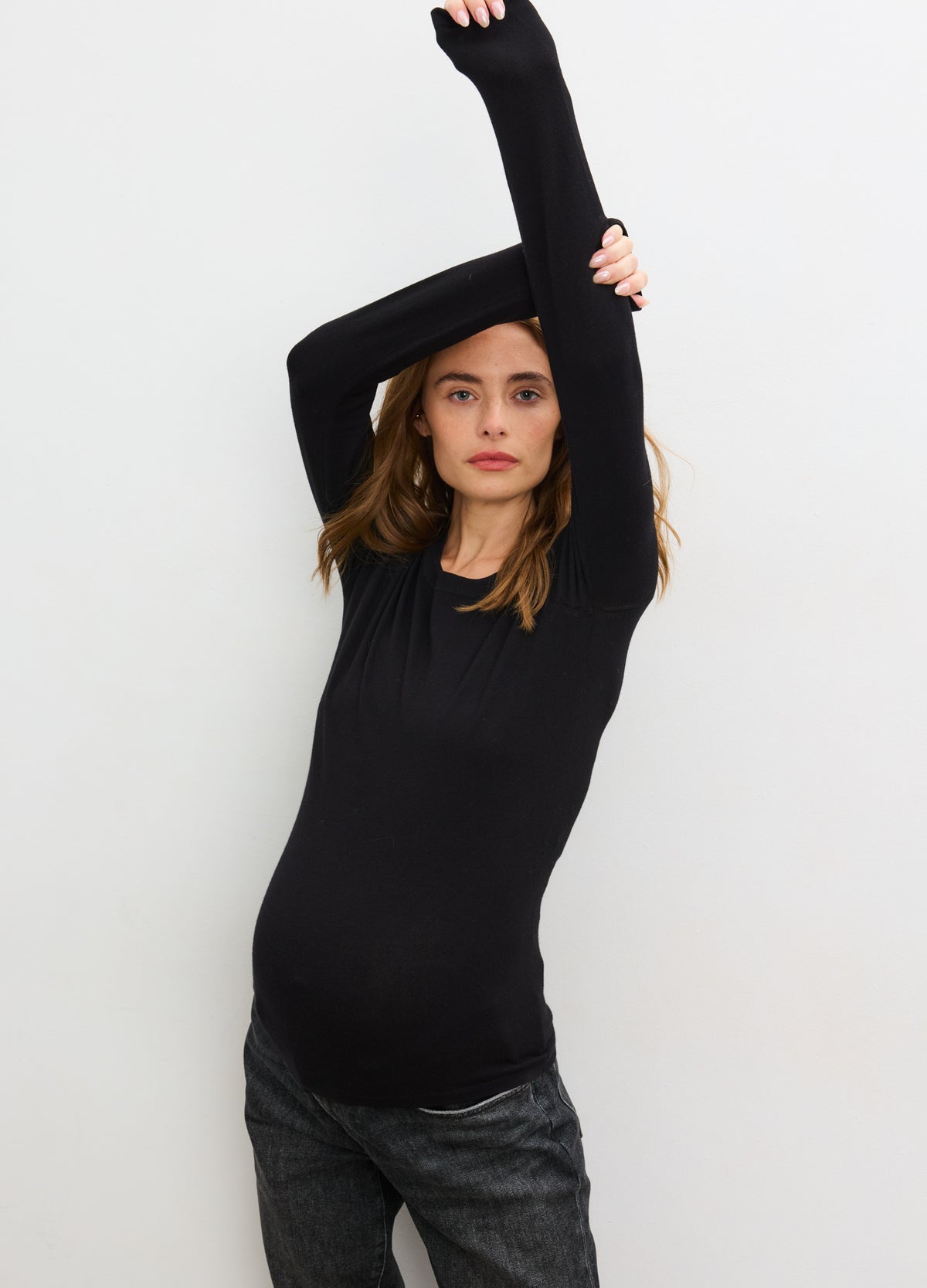 Black fitted knit long sleeve maternity top with stretchy, soft fabric and crew neckline.