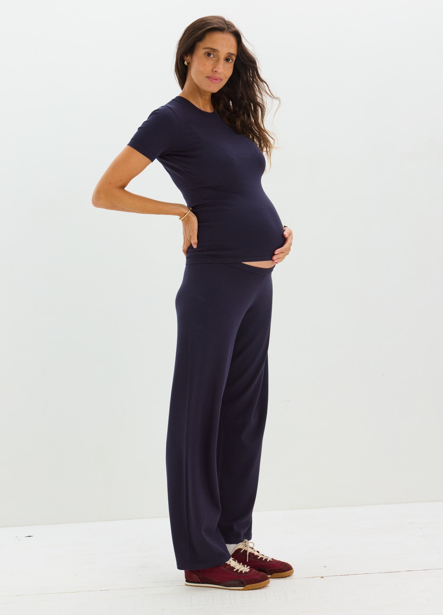 Navy blue knit maternity tee with short sleeves paired with matching wide-leg pants on pregnant woman.