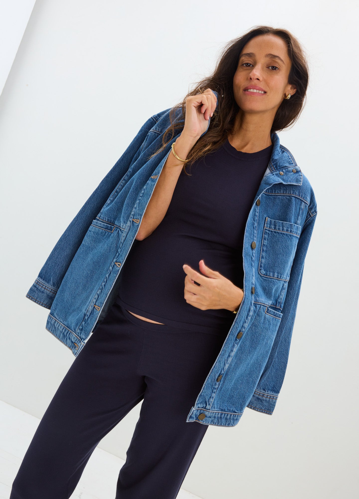 Navy blue maternity knit tee with short sleeves, paired with matching leggings and an oversized denim jacket draped over.
