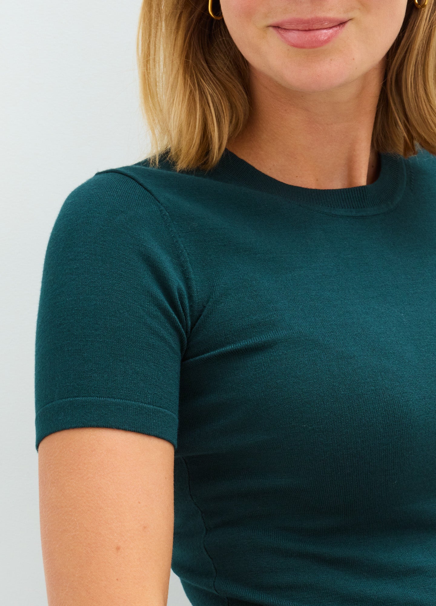 Teal short-sleeve maternity knit tee with a soft, stretchy fit designed for pregnant wearers.