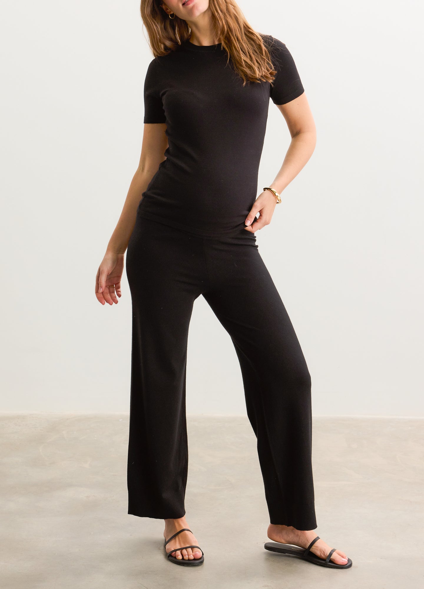 Black knit maternity crop pants with wide legs and a soft, stretchy waistband.