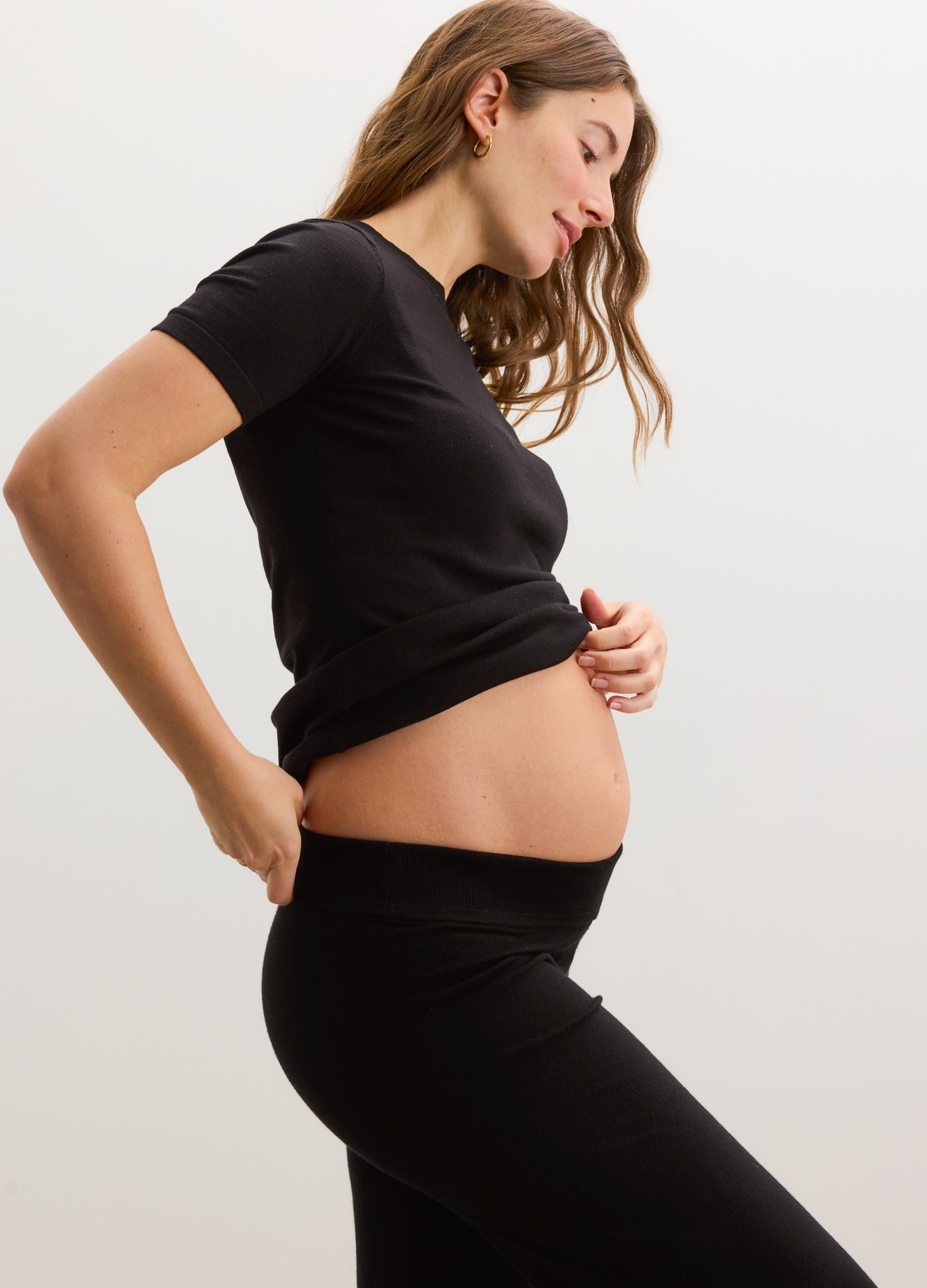 Black knit maternity crop pants with a soft, stretchy waistband designed for comfort.