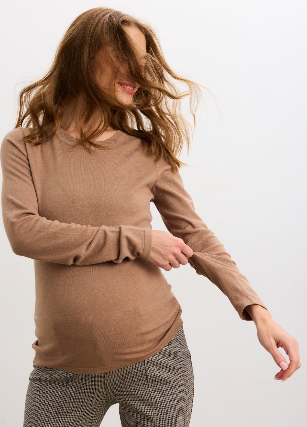 Mocha maternity long sleeve knit tee on pregnant model with fitted silhouette and soft texture.