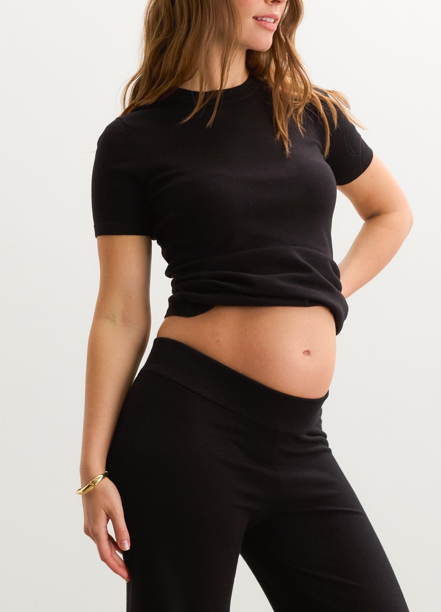 Black short-sleeve maternity knit tee with fitted soft stretch fabric and crew neckline.