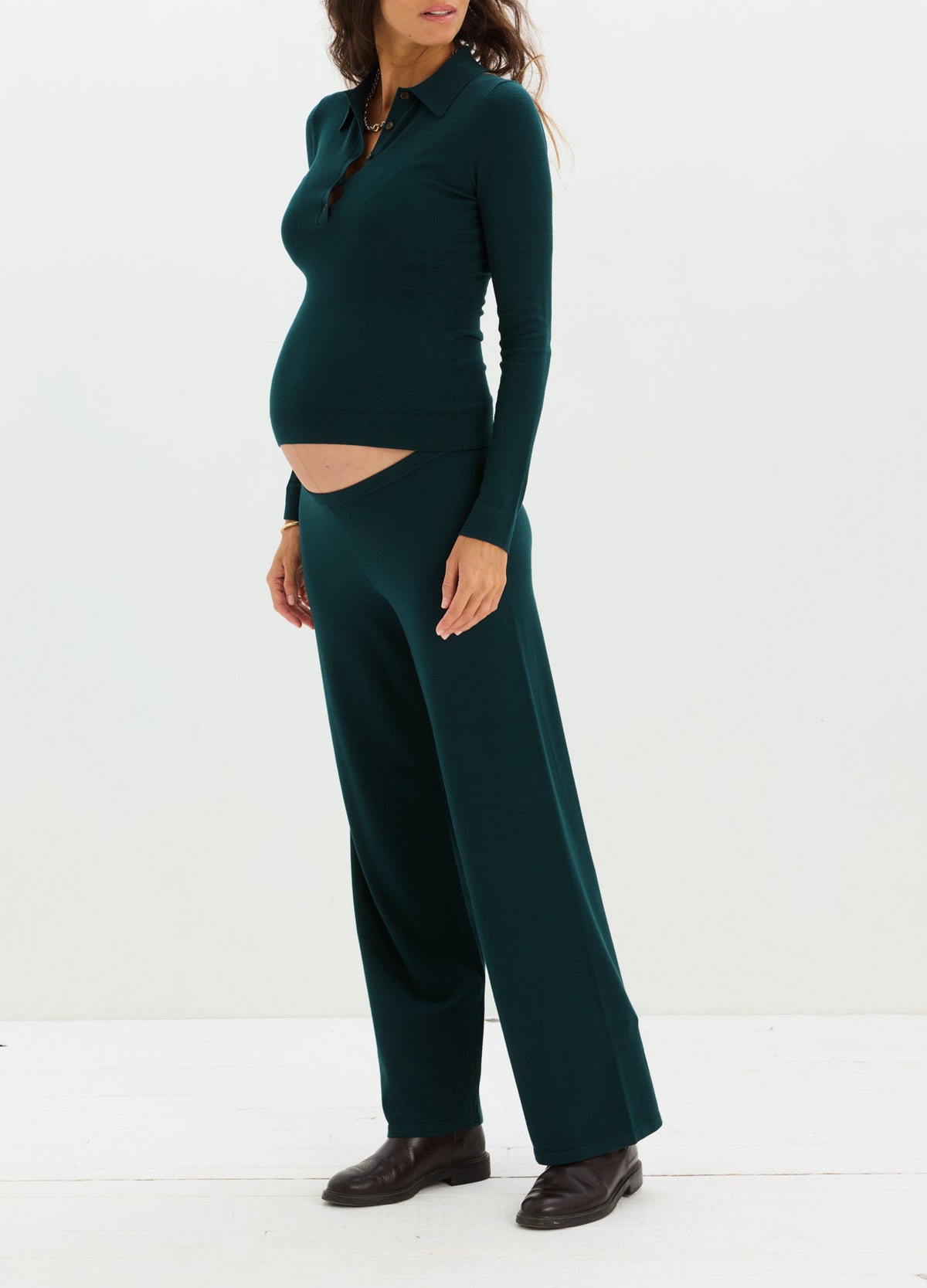 Dark green knit maternity pants with wide legs and a soft, stretchy waistband designed for pregnant comfort.