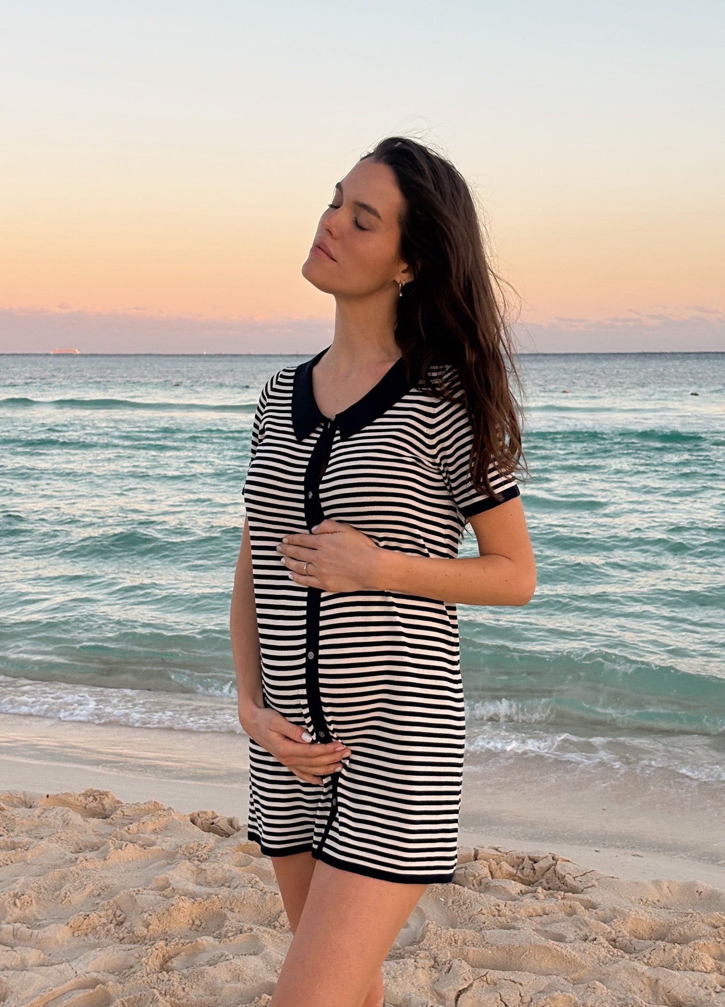 Black and white striped short-sleeve maternity dress with black collar and front buttons, knee-length.