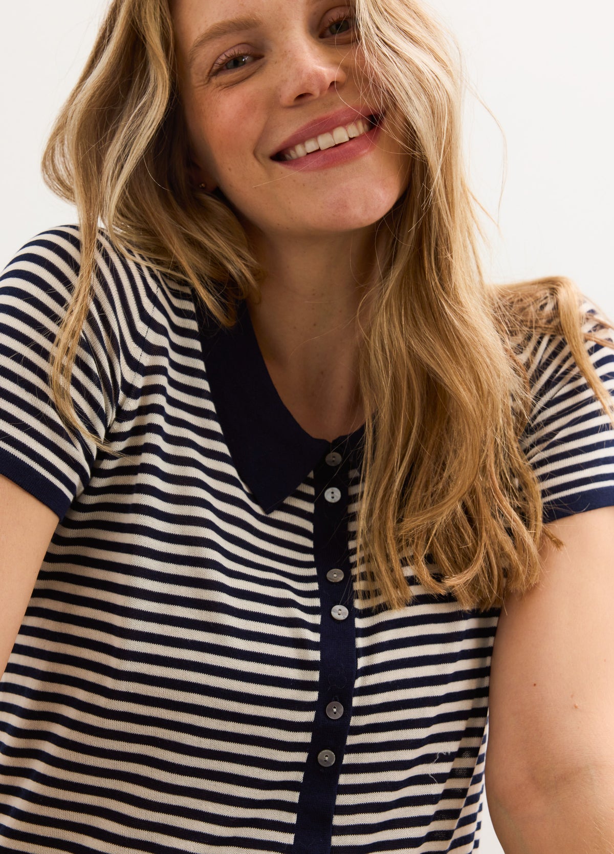 Navy and white striped maternity polo shirt with a navy collar and button-up front.