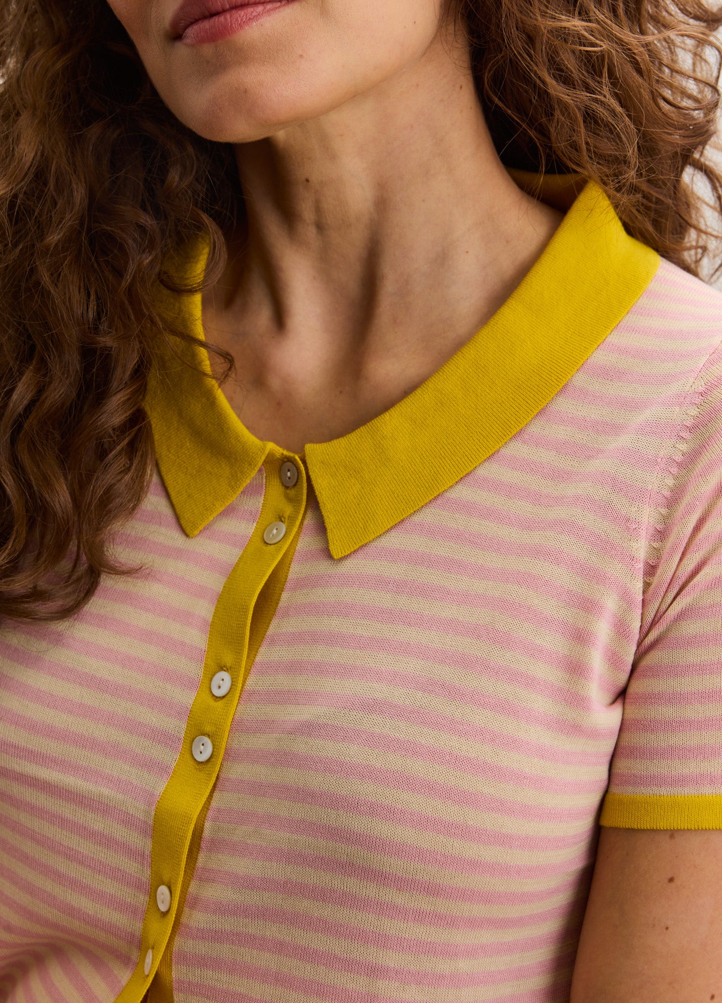 Pink and white striped maternity shirt with mustard yellow collar and button placket.