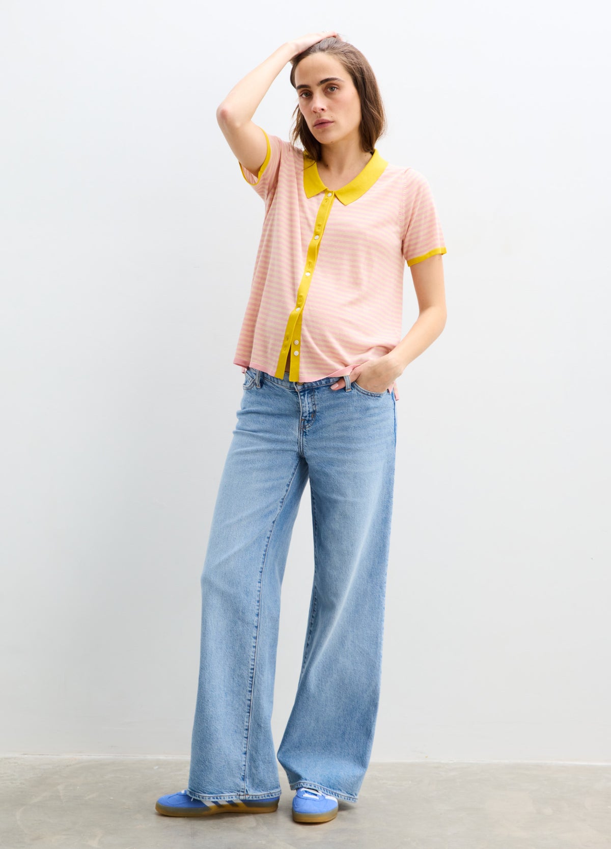 Light pink maternity shirt with yellow trim and buttons, short sleeves, relaxed fit.