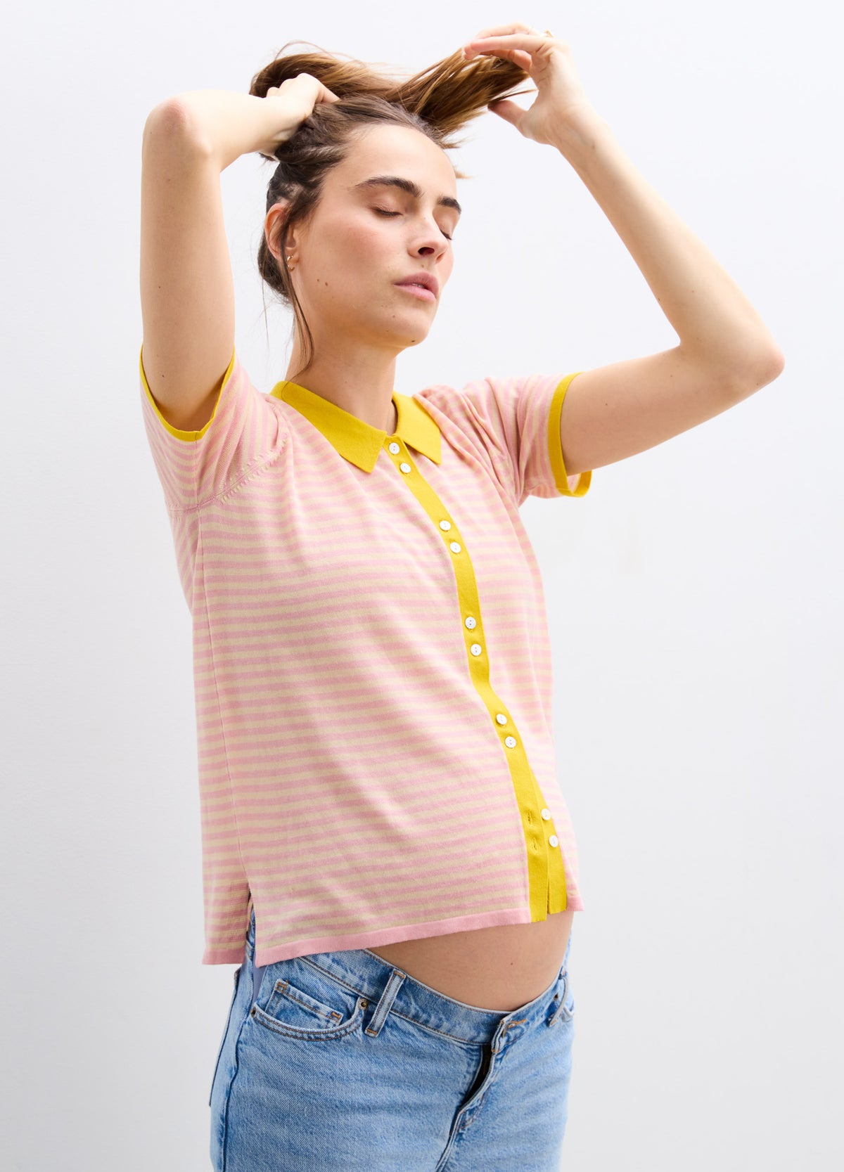 Pink and white striped maternity shirt with yellow collar and button placket, short sleeves.