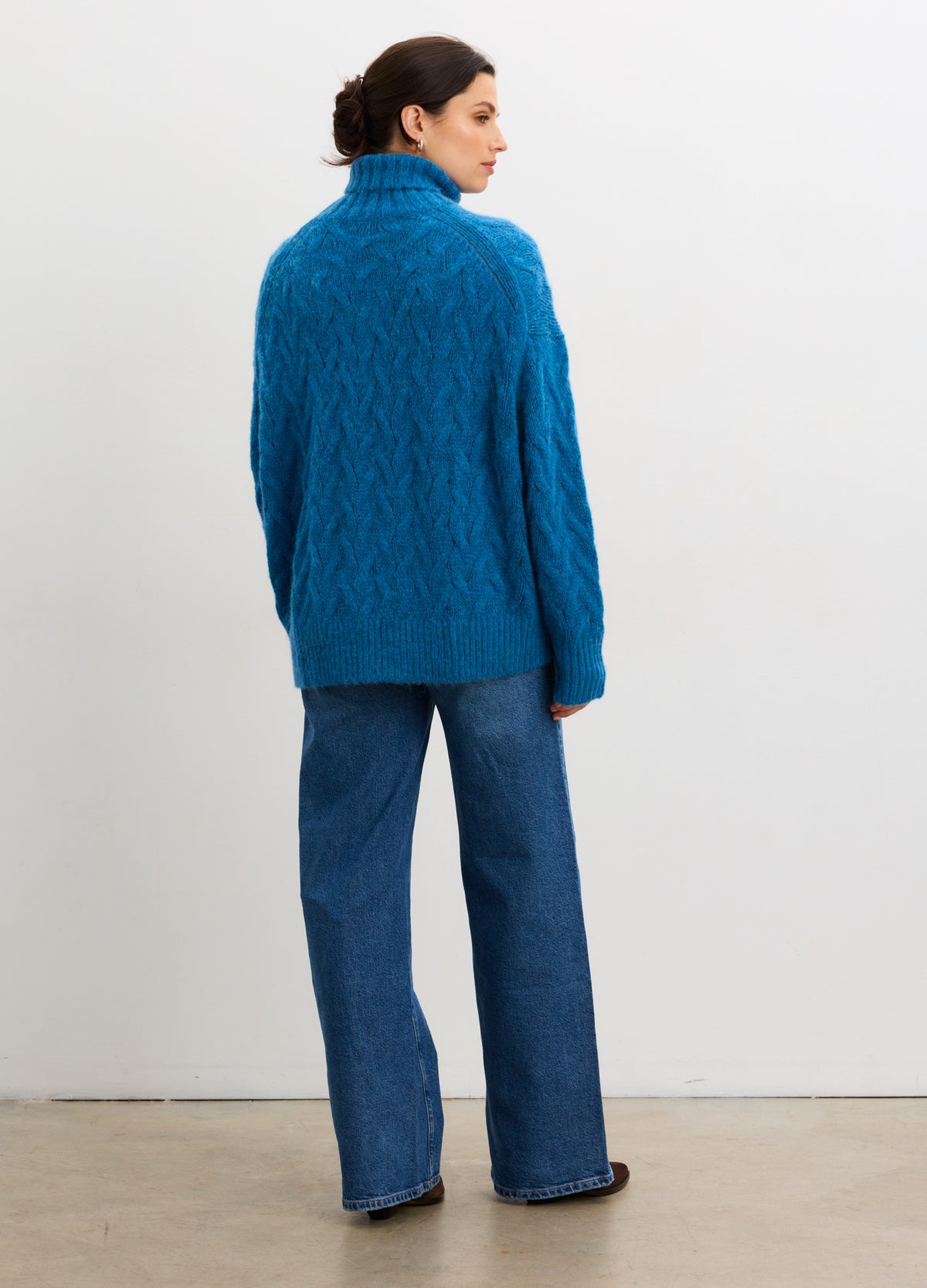 Teal cable-knit alpaca turtleneck sweater with long sleeves, loose fit, and maternity-friendly design.