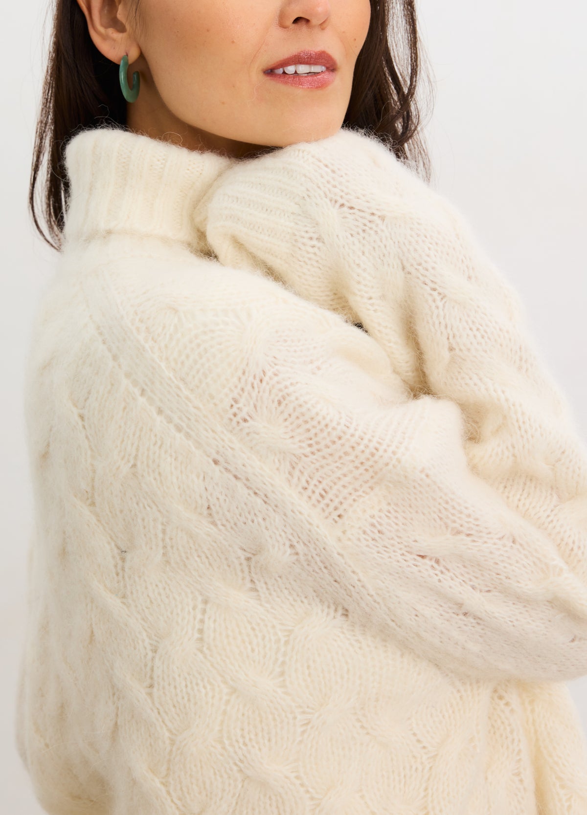 Ivory cable knit alpaca turtleneck sweater, soft texture, cozy maternity wear for pregnant women.
