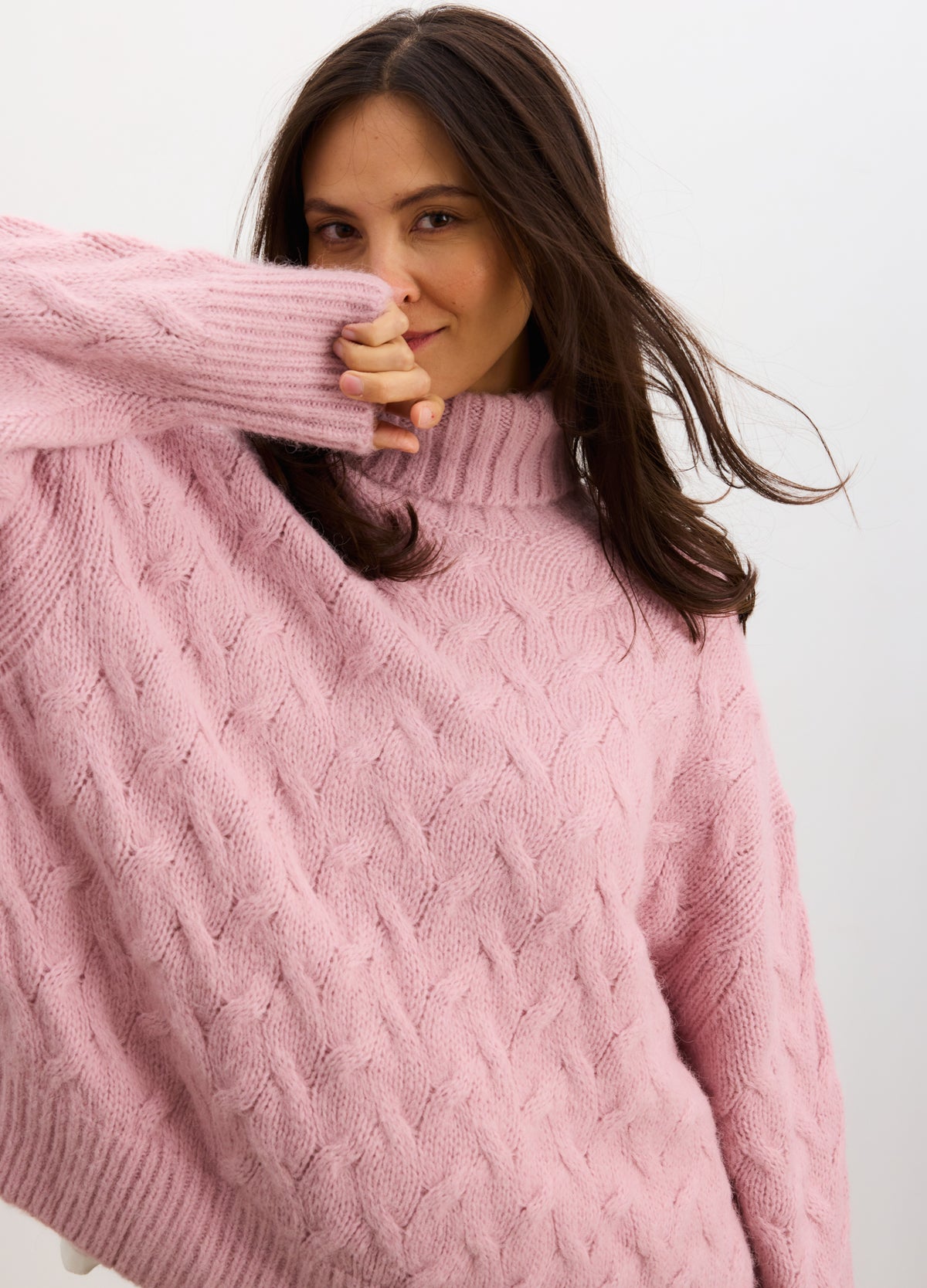 Lilac cable knit turtleneck sweater with relaxed fit, styled for pregnant maternity wear.